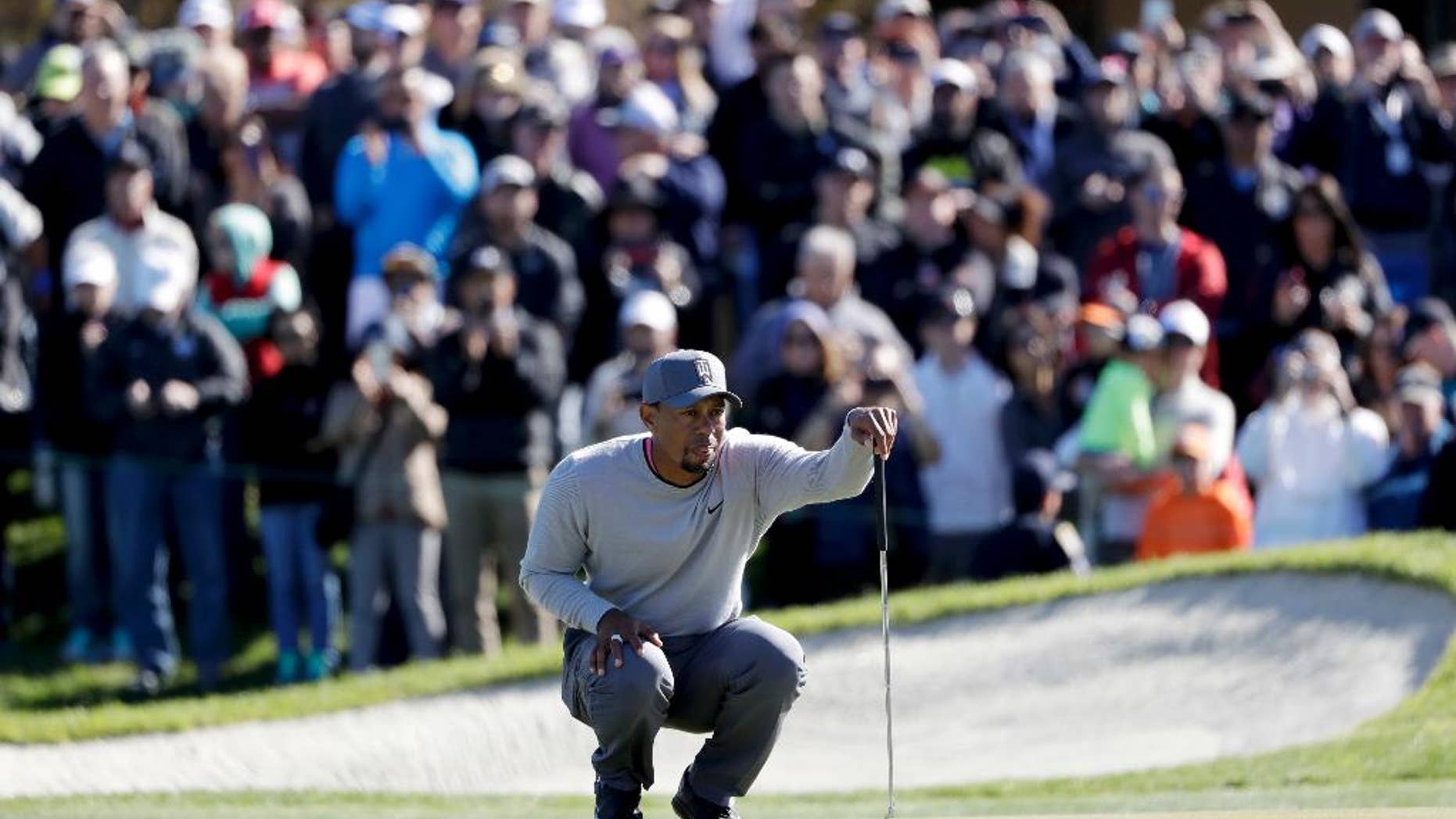 FILE - In this Friday, Jan. 27, 2017, file photo, Tiger Woods looks over his ball on the 18th hole of the North Course during the second round of the Farmers Insurance Open golf tournament at Torrey Pines Golf Course in San Diego. Woods has taken his talents to the Middle East to play in the Omega Dubai Desert Classic. The Phoenix Open is left with an expected 600,000 to see some of the rising young stars in the game, from Jordan Spieth to Justin Thomas, from Hideki Matsuyama of Japan to Jon Rahm of Spain.
(AP Photo/Gregory Bull, File)