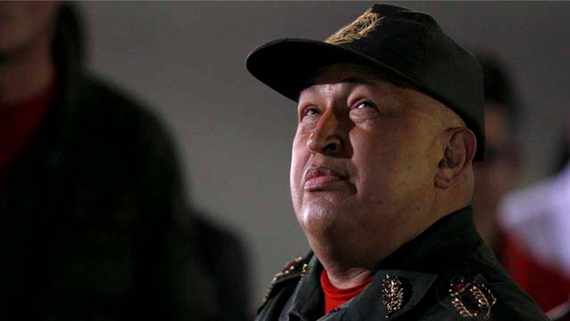 Venezuela's President Hugo Chavez looks up upon his arrivals to Miraflores presidential palace after his third round of chemotherapy for cancer.in Caracas, Venezuela, Friday, Sept. 2, 2011. Venezuelan President Hugo Chavez said he felt great and playfully boxed for television cameras as he emerged from his third round of chemotherapy for cancer.(AP Photo/Fernando Llano)