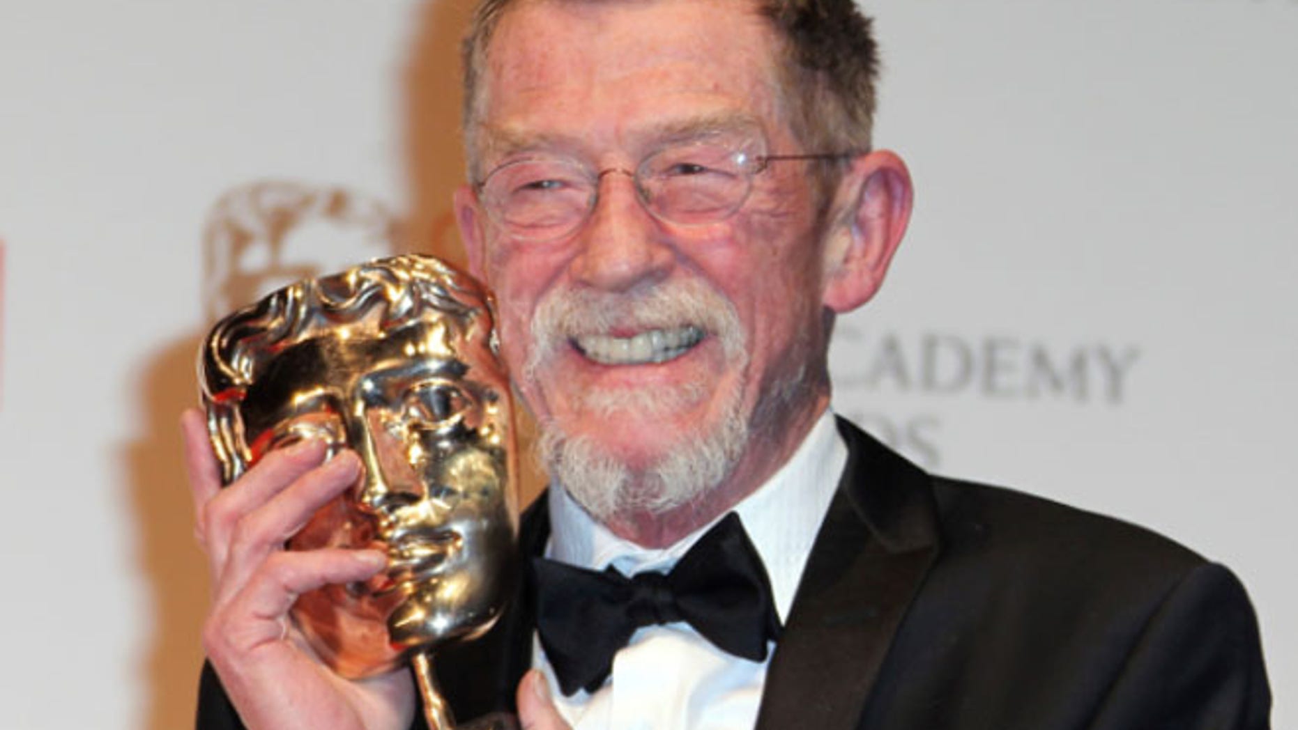 FILE 2012: Actor Sir John Hurt posing with his award for "Outstanding Contribution to Cinema" backstage at The Royal Opera House in London.