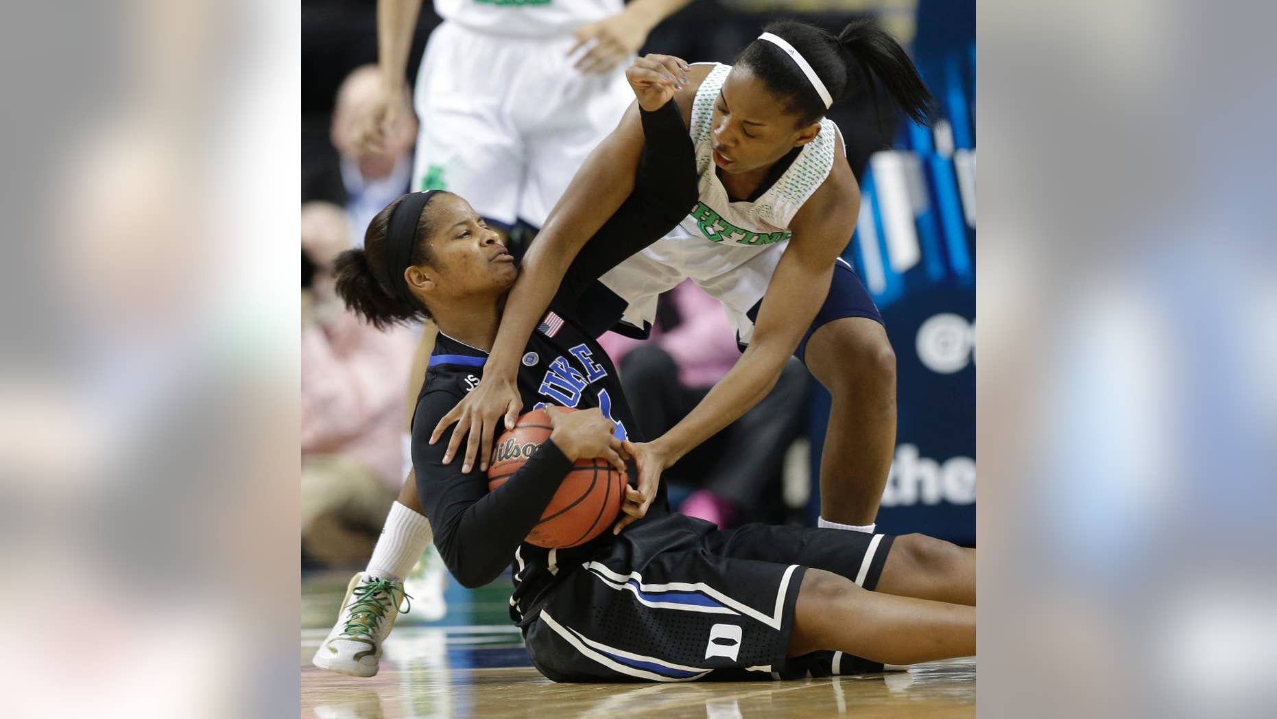 Notre Dame's Lindsay Allen, right, reaches in on Duke's Ka'lia Johnson, left, during the second half of the NCAA college basketball championship game in the Atlantic Coast Conference tournament in Greensboro, N.C., Sunday, March 9, 2014. (AP Photo/Chuck Burton)