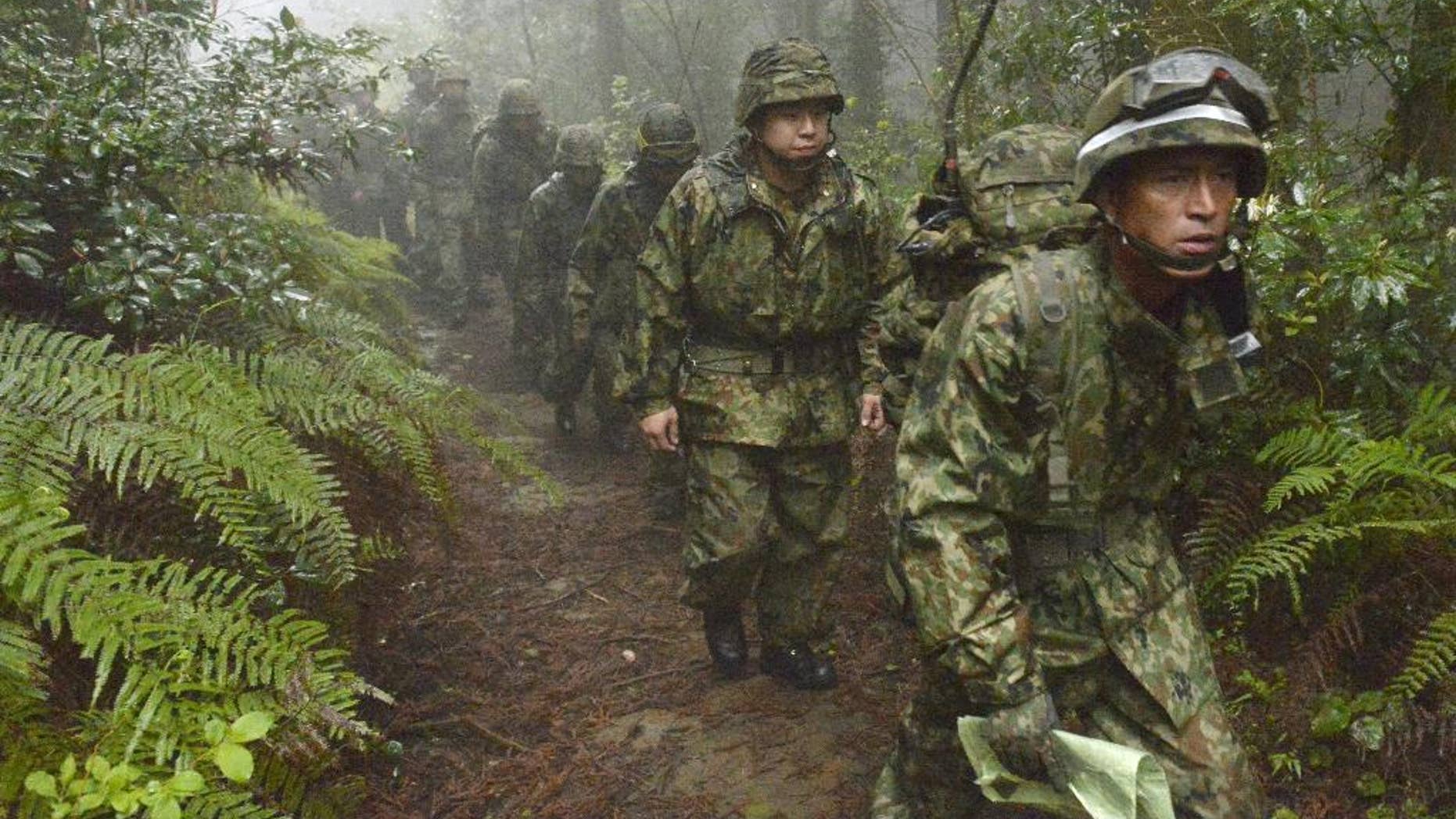 Members of the Japan Self-Defense Forces resume a search operation for a disapeared Japanese military jet carrying six airmen, in Kanoya city, Kagoshima prefecture, southern Japan, Thursday, April 7, 2016. The military jet carrying six airmen disappeared from radar over southern Japan on Wednesday afternoon, and the search has been suspended for the night. The plane disappeared about an hour after takeoff from Kanoya base for what was supposed to be a three-hour flight, the Defense Ministry said. (Sadayuki Goto/Kyodo News via AP) JAPAN OUT, CREDIT MANDATORY