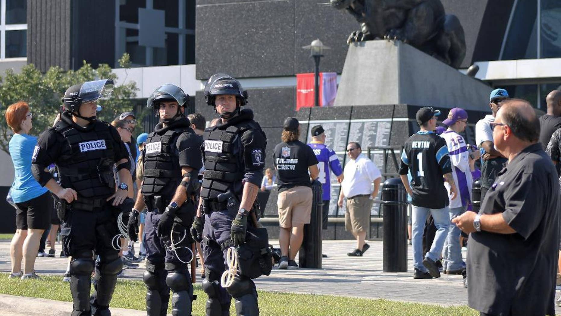 Police officers stand outside Bank of America Stadium for an NFL football game between the Minnesota Vikings and the Carolina Panthers, Sunday, Sept. 25, 2016. Extra security was posted outside the stadium in response to protests over the shooting death of a black man by a police officer on Sept. 20. (AP Photo/Skip Foreman)