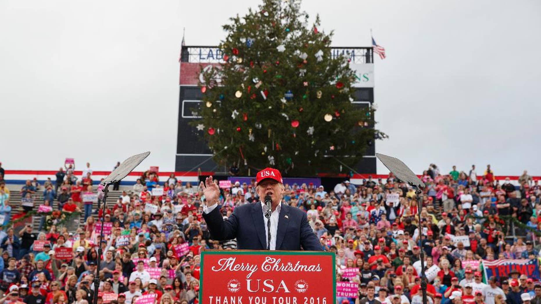 FILE - In this Saturday, Dec. 17, 2016, file photo, President-elect Donald Trump speaks during a rally at Ladd-Peebles Stadium in Mobile, Ala. Authorities in Mobile said the tree cut down in a city park and used as a prop at Trump’s recent rally will be used to build cat scratching posts and bird houses. The mayor’s chief of staff apologized for his role in having the large cedar tree cut down, saying he was “overzealous” in trying to meet expectations of Trump’s team. (AP Photo/Evan Vucci, File)