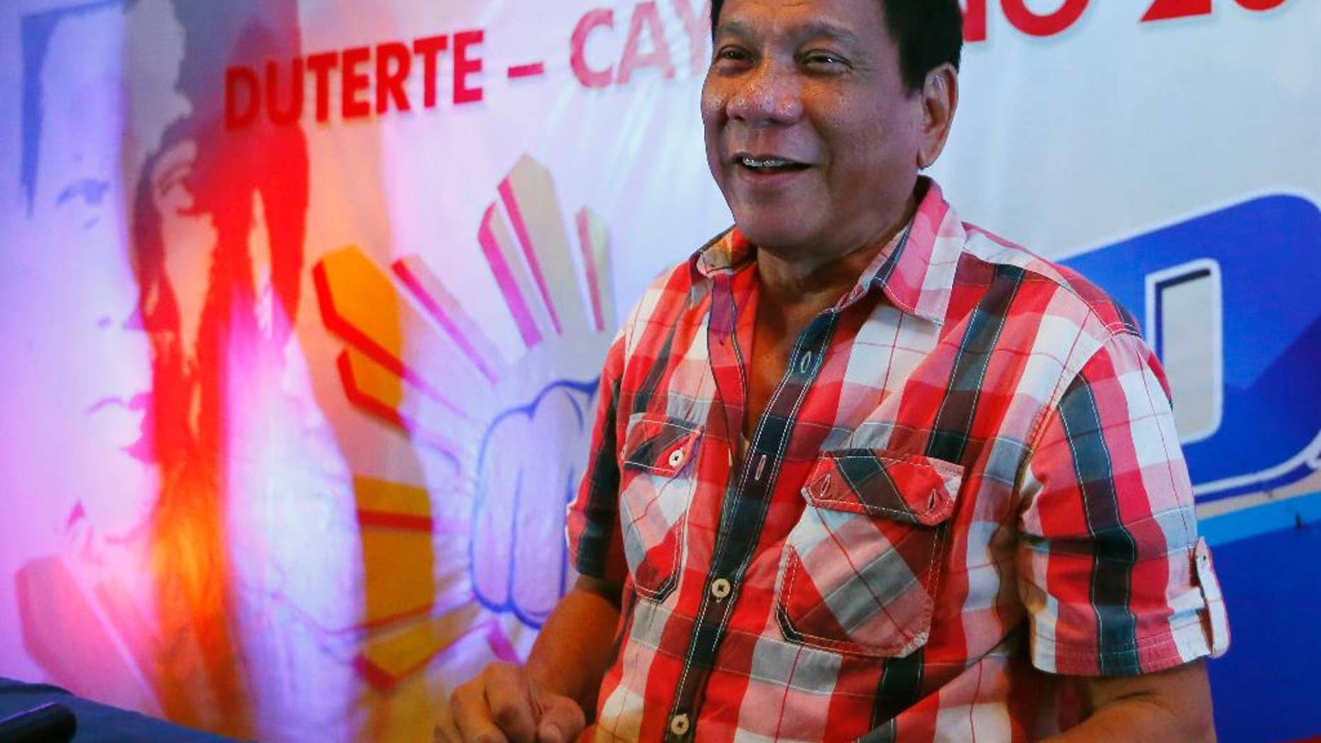 Front-running presidential candidate Mayor Rodrigo Duterte smiles during a news conference shortly after voting in a polling precinct at Daniel R. Aguinaldo National High School, Matina district, his hometown in Davao city, southern Philippines Monday, May 9, 2016. Duterte was the last to vote among five presidential hopefuls. (AP Photo/Bullit Marquez)
