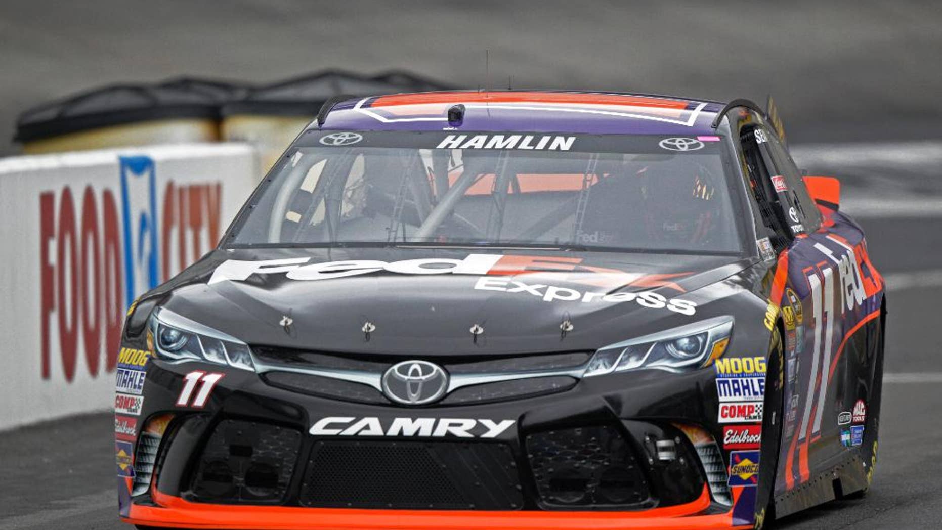 Denny Hamlin makes his way down pit road during practice for a NASCAR Sprint Series auto race on Friday, Aug. 19, 2016 in Bristol, Tenn. (AP Photo/Wade Payne)
