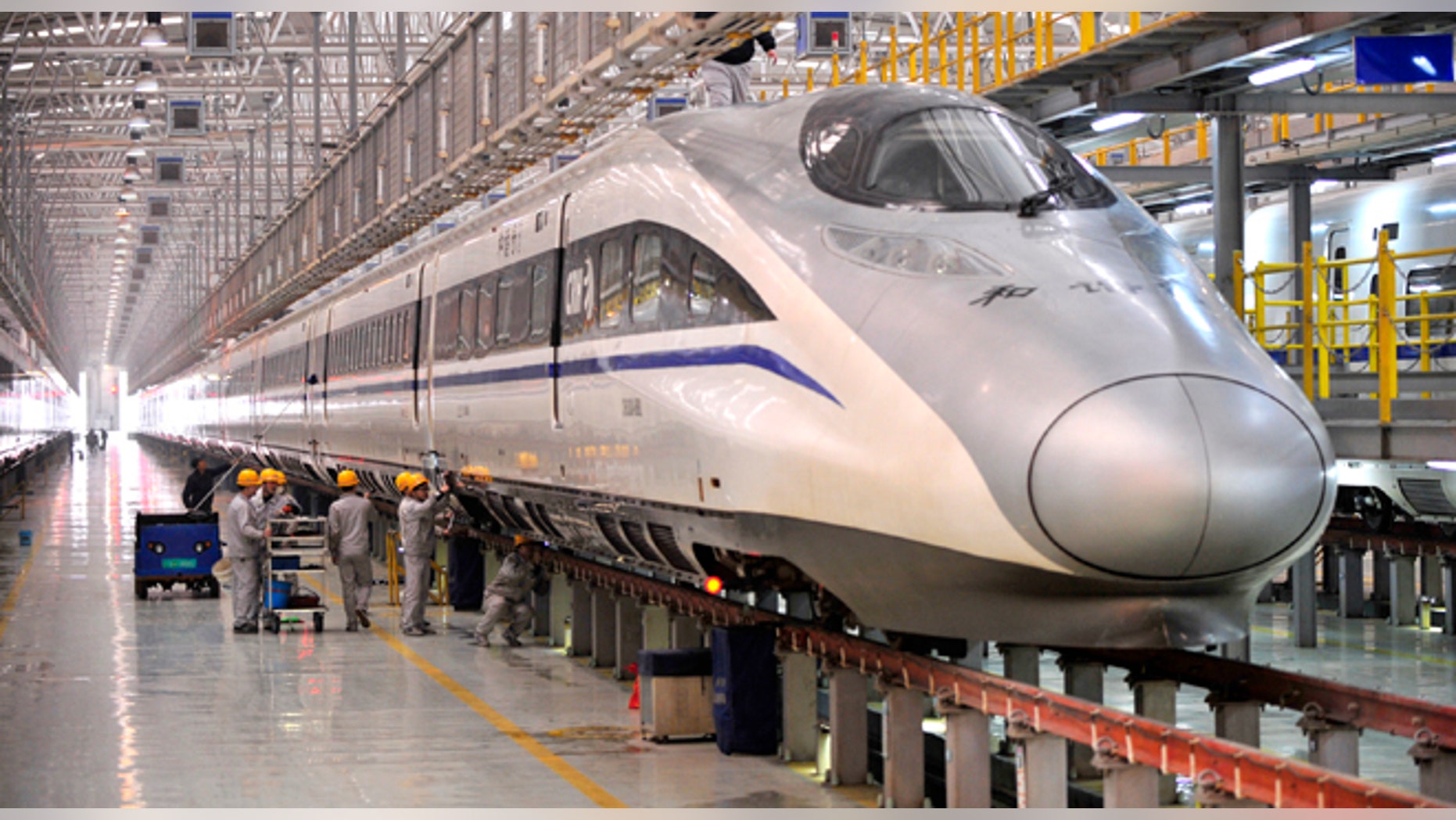 XI AN, CHINA - JANUARY 07: (CHINA OUT) Mechanics check a high-speed train at Xi'an Electric Multiple Unit Maintenance Base on January 7, 2014 in Xi An, China. The 40-day 2014 Spring Festival travel rush will start on January 16 as more than 257 million passenger trips will be made on the railways. (Photo by ChinaFotoPress/Getty Images)