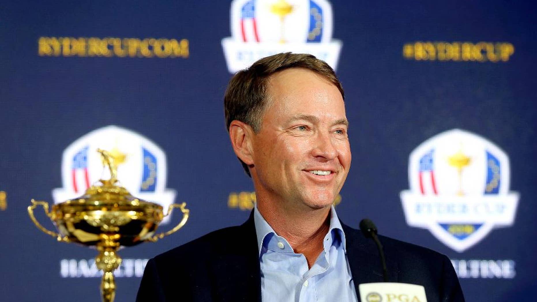 FILE - In this Feb. 24, 2015, file photo, Davis Love III smiles during a news conference introducin him as the 2016 U.S. Ryder Cup captain, at PGA of America in Palm Beach Gardens, Fla. The last Ryder Cup felt like the last straw for the Americans. After yet another loss to Europe, the Americans created a task force to try to find the best captain, to develop the best process for picking a team to have the best chance at winning. (Bill Ingram/Palm Beach Post via AP, File
