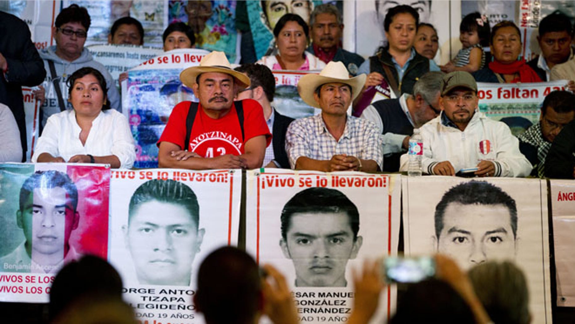 Relatives of 43 missing students, accompanied by their spokesman and human rights activists, take their seats during a press conference. (AP Photo/Rebecca Blackwell)