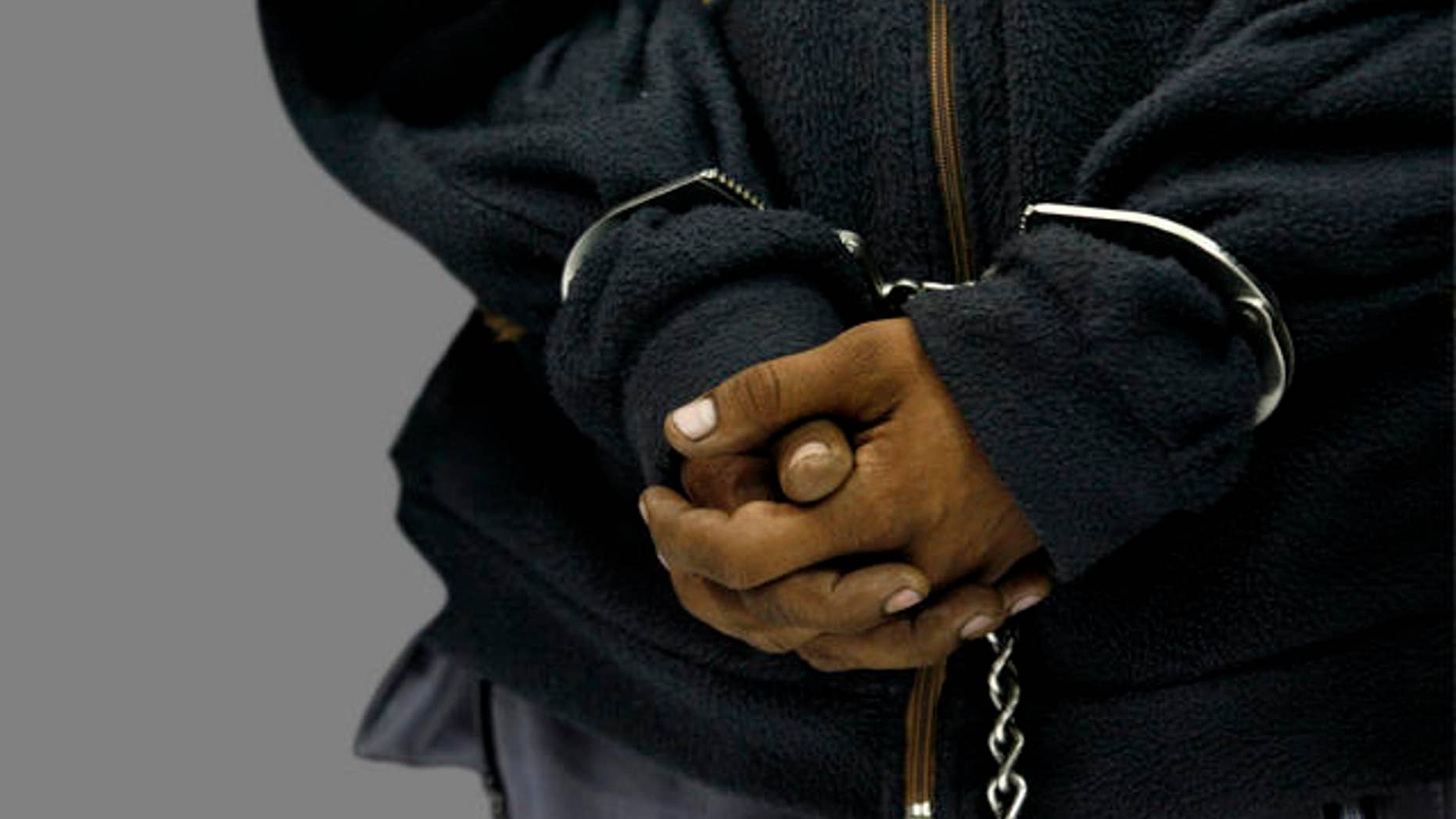 The hands of Raul Ortiz Gonzalez, an alleged member of kidnapping gang "Los Rojos," are handcuffed as he is presented to the press after his arrest in Mexico City, Wednesday, July 29, 2009. Ortiz is a suspect in the 2007 kidnapping and murder of Silvia Vargas. (AP Photo/Marco Ugarte)
