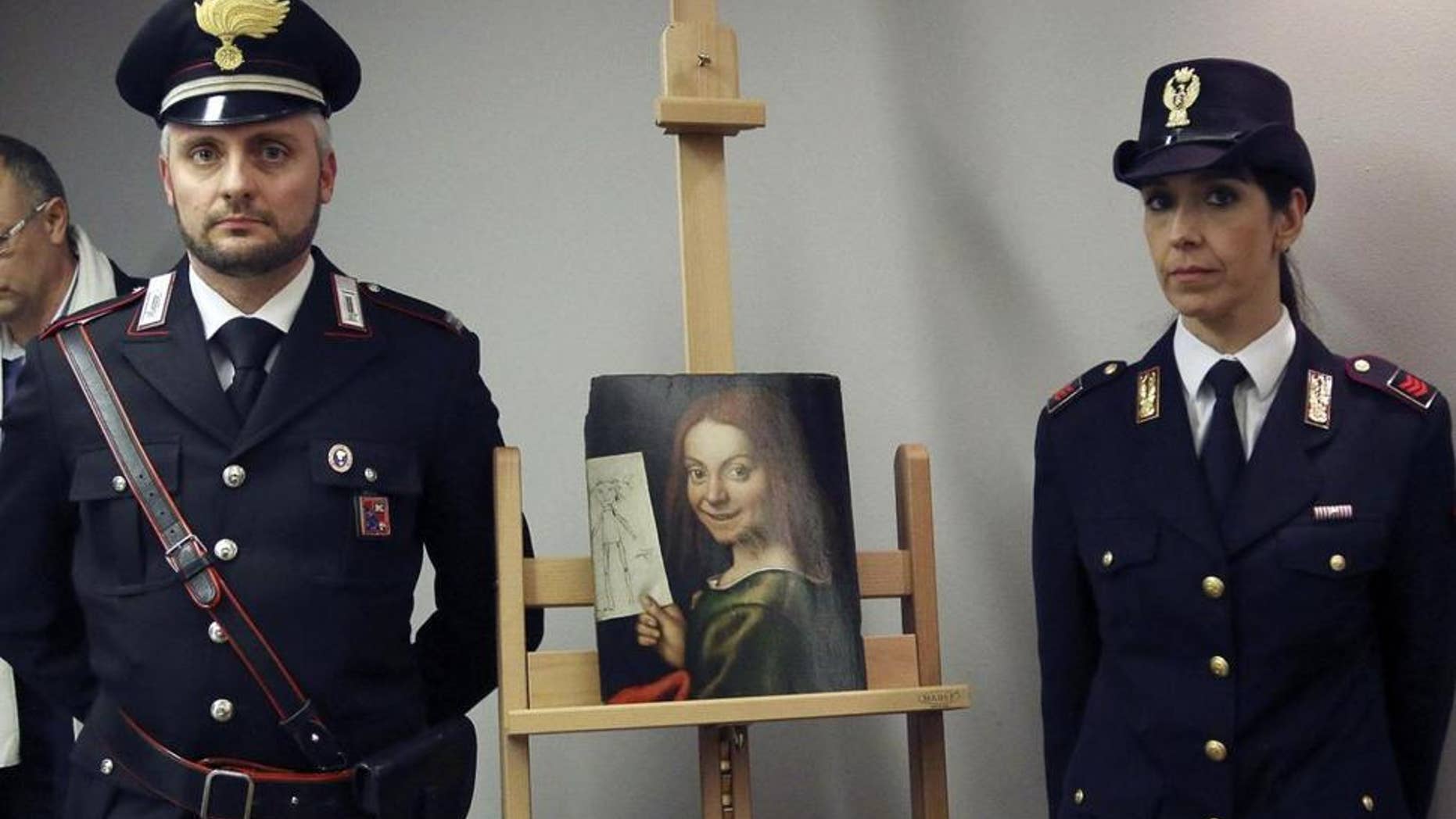 Carabinieri and police officers pose with one of the recovered paintings that were stolen from a Verona museum, at the Verona airport in Italy.