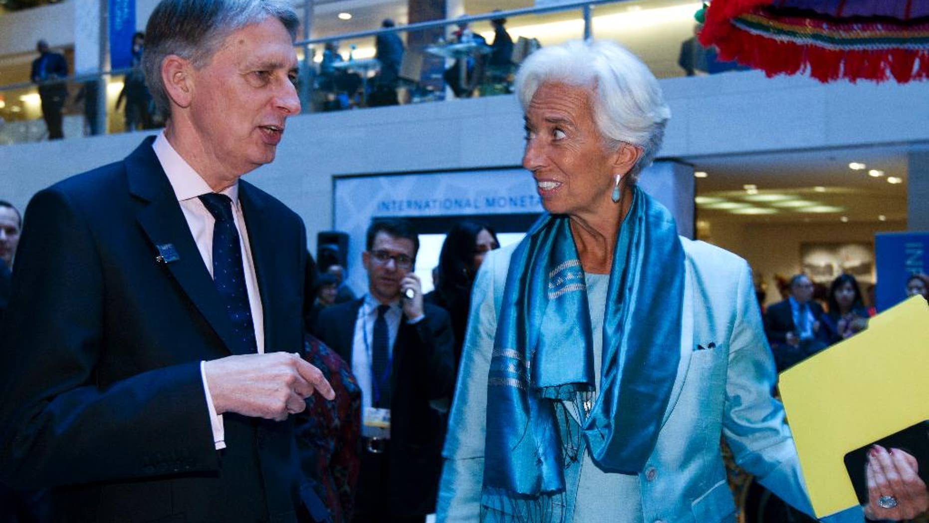International Monetary Fund (IMF) Managing Director Christine Lagarde speaks with Chancellor of the Exchequer Philip Hammond after a news conference at World Bank/IMF Annual Meetings at IMF headquarters in Washington, Saturday, Oct. 8, 2016. ( AP Photo/Jose Luis Magana)