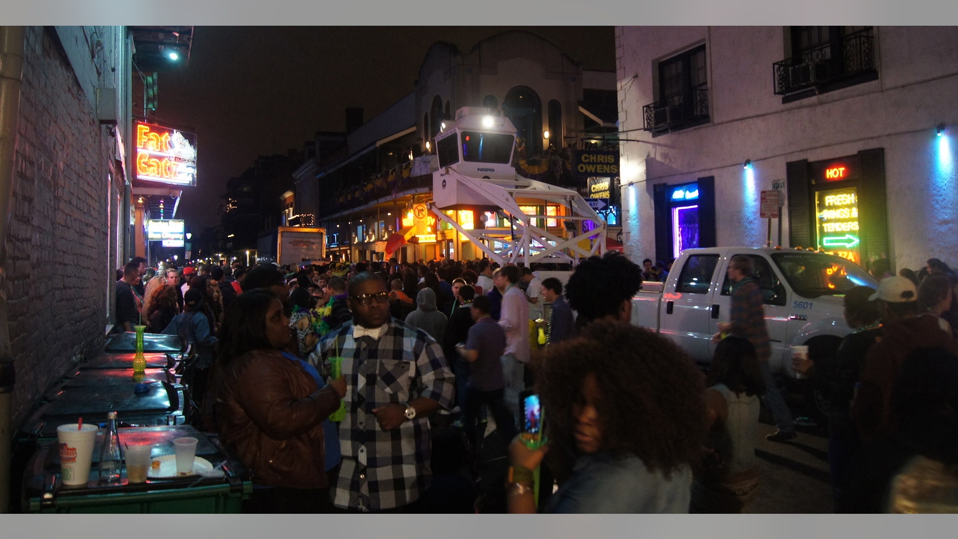 From a security tower above the Mardi Gras crowds, NOPD officers watch the 400 and 500 blocks of Bourbon Street after four people were shot around 9:30 p.m. Saturday, Feb. 9, 2013. (AP Photo/The Times-Picayune, Naomi Martin)
