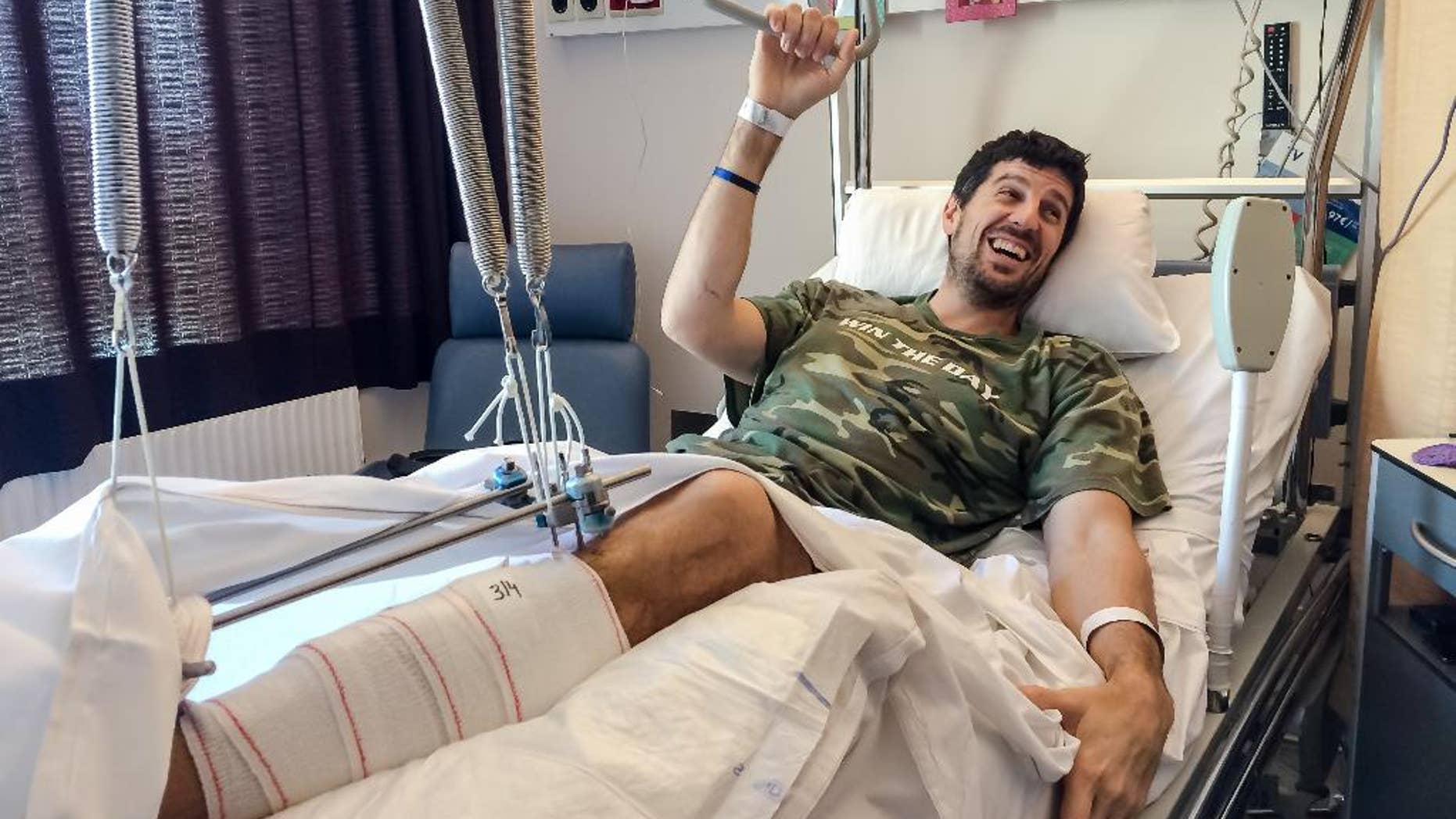 In this photo taken on Sunday, April 3, 2016, Belgian professional basketball player Sebastien Bellin rests in his bed in Erasmus University Hospital in Brussels. Sebastien Bellin, a 6-foot-9 giant once celebrated for his skills on the basketball court, is today better known as the man who was photographed lying bloody on the floor of Brussels’ main airport after the March 22 bombings. But as he recovers at the Erasmus Hospital in Brussels, Bellin says he is grateful the picture was taken. It shows him how close to death he was, and reminds him of all the people who helped save his life. (AP Photo/Helene Franchineau)