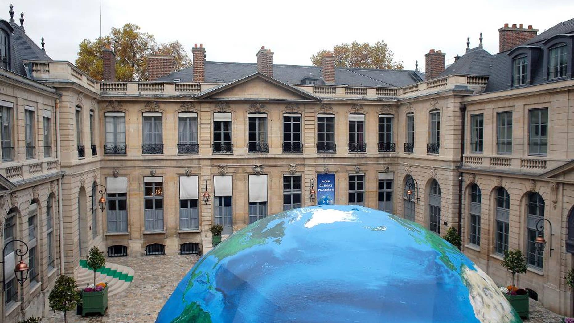 An globe-like tent hosting an exhibition on climate is set up in the courtyard of the French Environment ministry as part of the Nov. 30-Dec. 11 climate conference, in Paris, France, Friday, Nov. 6, 2015. Some 80 heads of state including President Barack Obama, and tens of thousands of other people, are expected in Paris for the conference opening. (AP Photo/Thibault Camus)