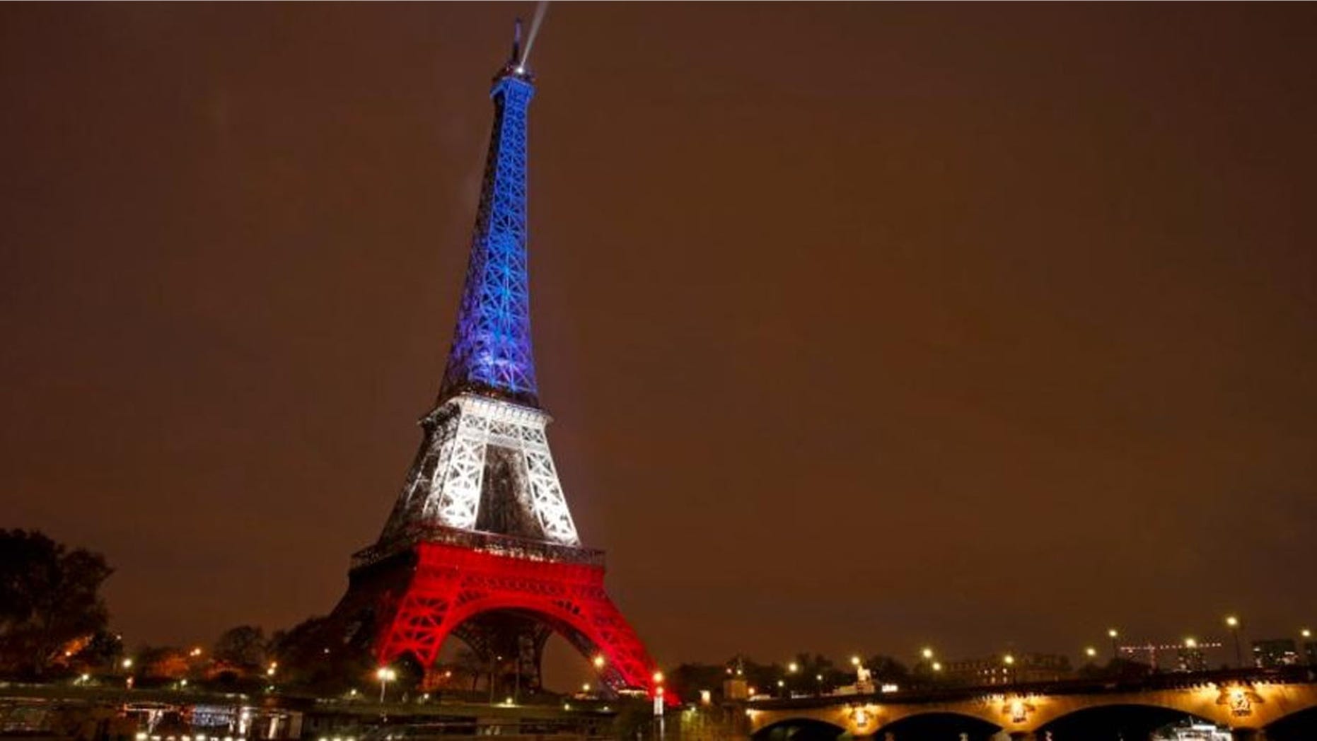 Nov. 16, 2015: The Eiffel Tower is lit with the blue, white and red colors of the French flag in Paris to pay tribute to the victims of a series of deadly attacks on Friday in the French capital.
