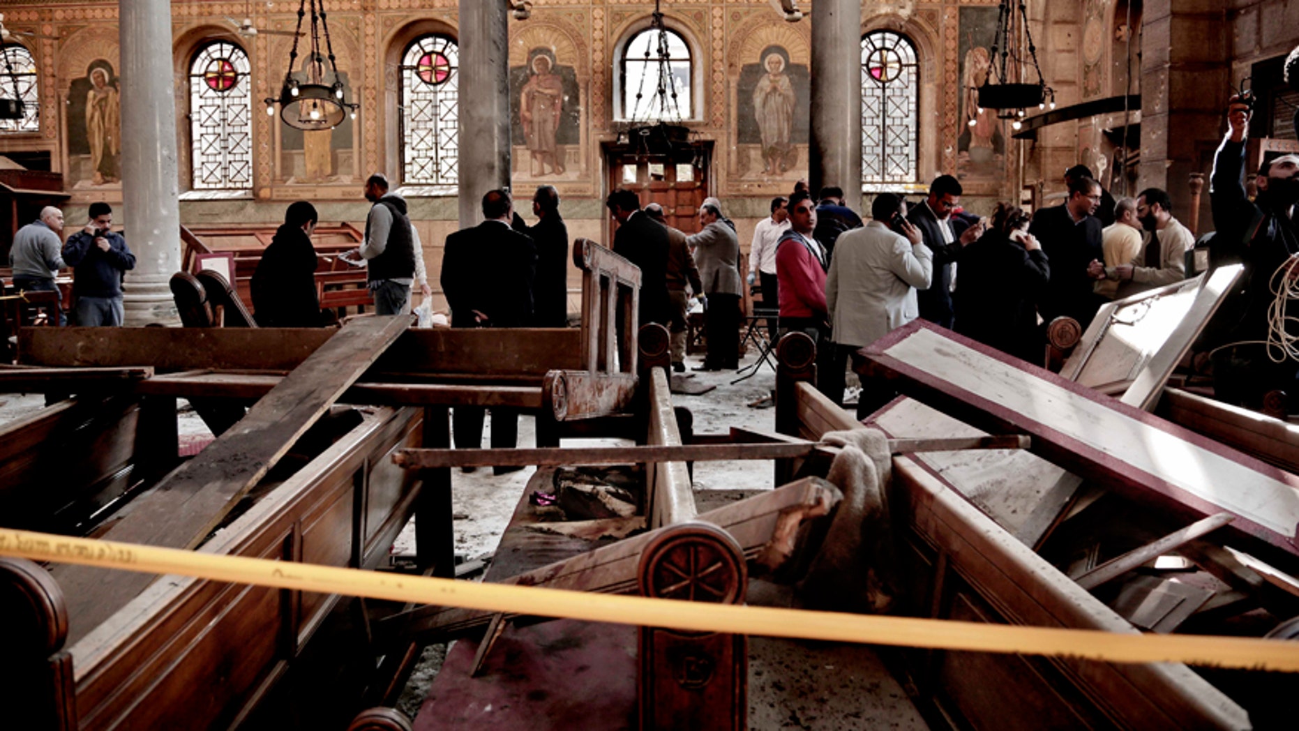 In this Dec. 11, 2016 file photo, security forces examine the scene inside the St. Mark Cathedral in central Cairo, following a bombing that killed dozens of people.