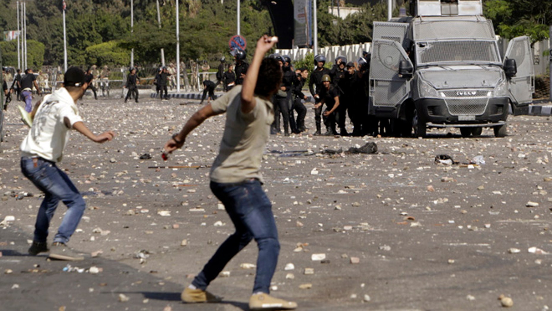 Oct. 20, 2013: Protesters throw stones during clashes with riot police in front of the main offices of Al-Azhar University in Cairo. Egyptian security forces fired bird shot and tear gas to prevent supporters of deposed Islamist President Mohamed Morsi from marching on Sunday to the site of a protest camp at Rabaa al-Adaweya mosque that was destroyed two months ago, a Reuters witness said.