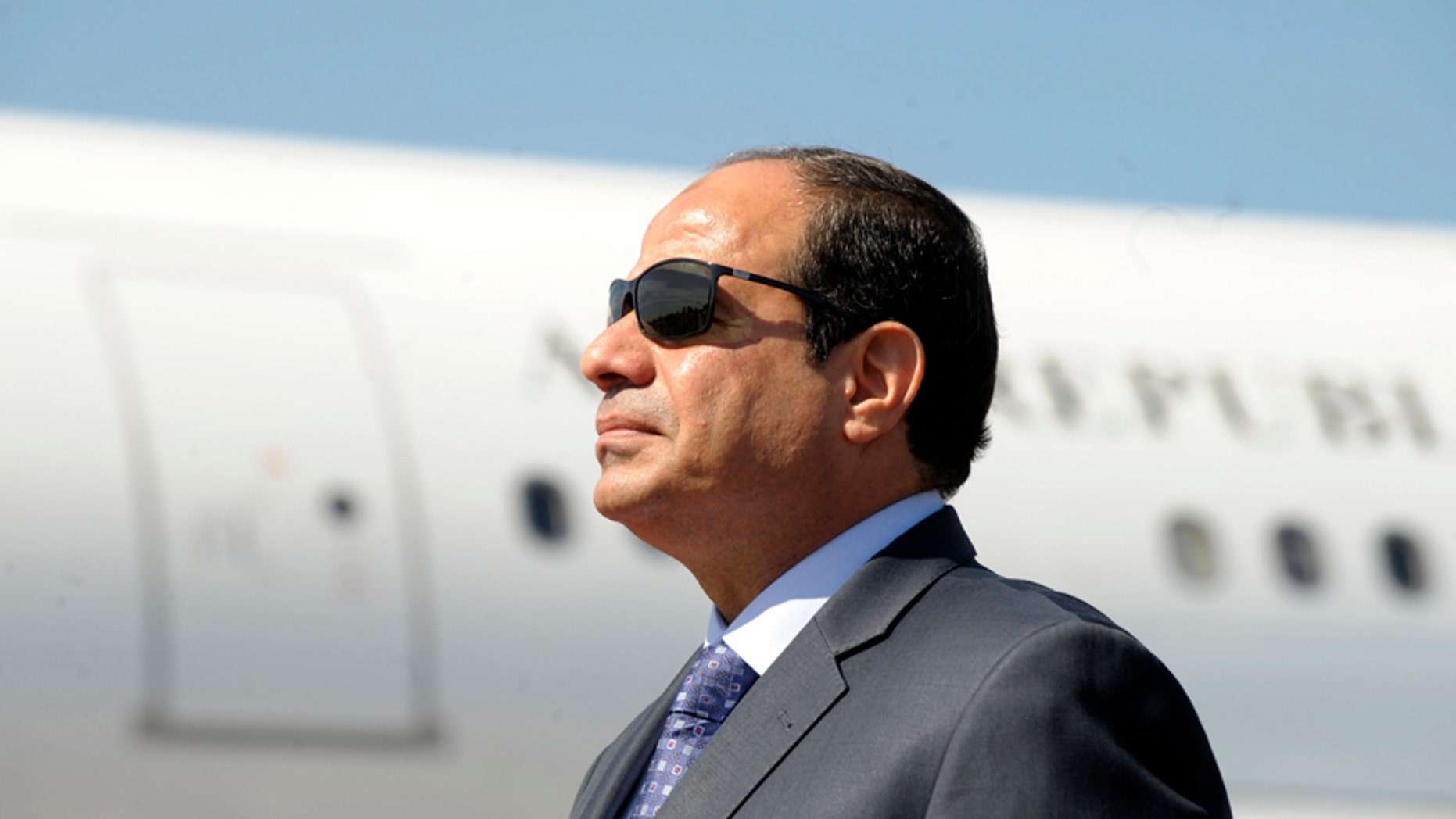 FILE - In this June 25, 2014, file photo, Egyptian President Abdel-Fattah el-Sissi stands at Algiers airport on his arrival to Algiers, Algeria. News that Egypt's parliament speaker and his two deputies are using state funds to get cars worth hundreds of thousands of dollars has sparked a furor days after the president said Egypt was "poor, very, very poor." (AP Photo/Sidali Djarboub, File)