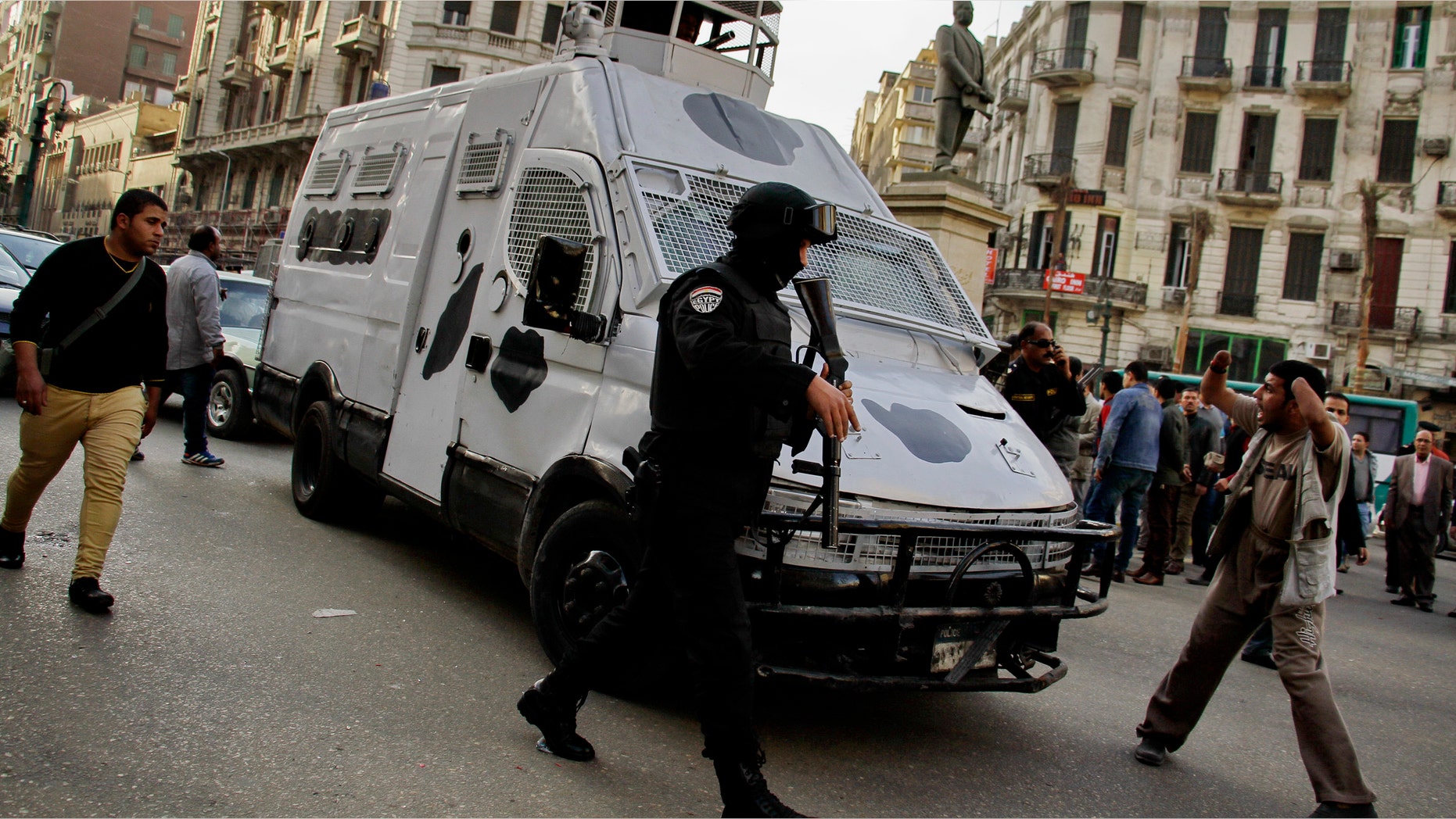 Jan. 22, 2015: A member of the Egyptian security forces disperses people gathering to protest against a court order to release the two sons of ousted Egyptian President Hosni Mubarak in Talaat Harb Square downtown Cairo, Egypt. (AP)