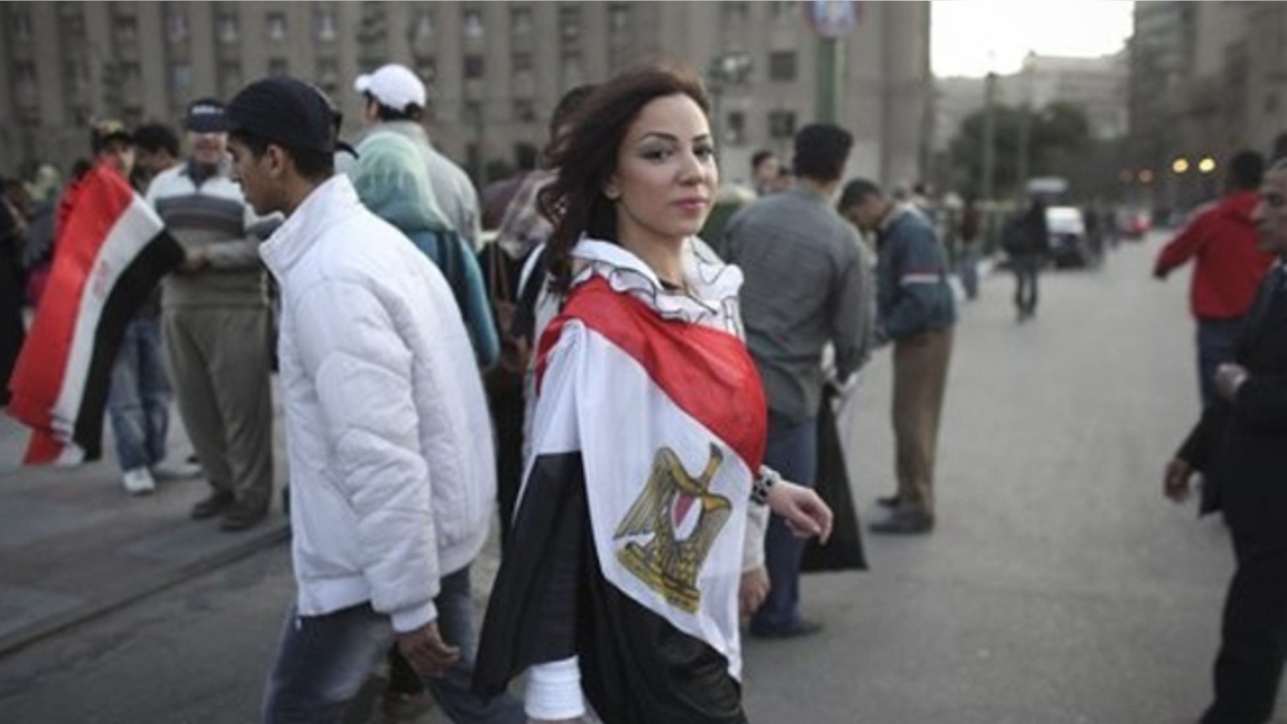 Feb. 13, 2011: A woman wearing an Egyptian flag walks into Tahrir Square, in Cairo, Egypt