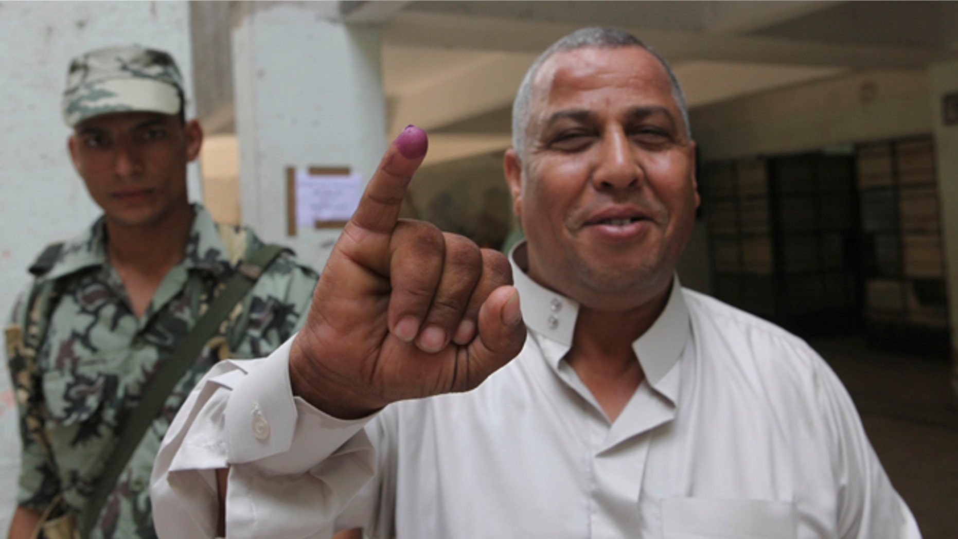 June 16, 2012: An Egyptian voter displays his ink-stained finger, proving he cast his ballot, in a polling station in Cairo, Egypt.