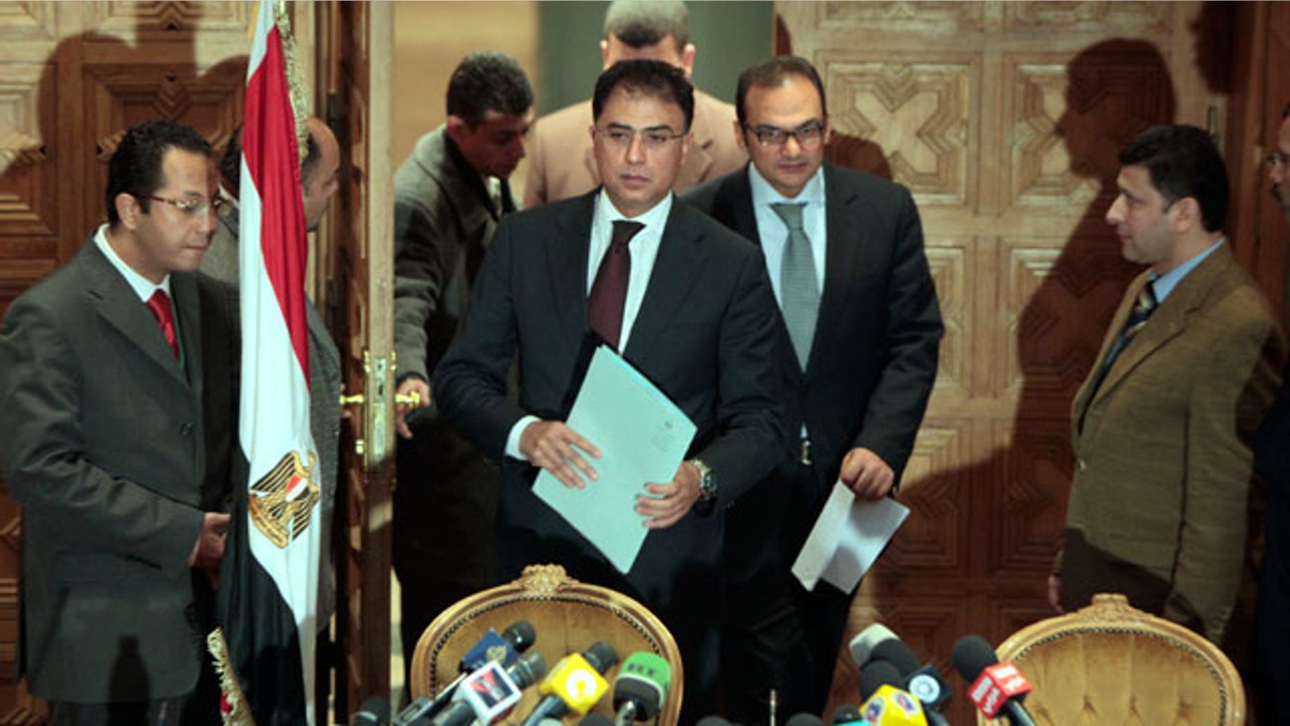 Feb. 8, 2012: Egyptian investigative judges Sameh Abu Zeid, right, and Ashraf el-Ashmawi, who are investigating the case of foreign funding of NGOs, enter a press conference at the Ministry of Justice in Cairo, Egypt.