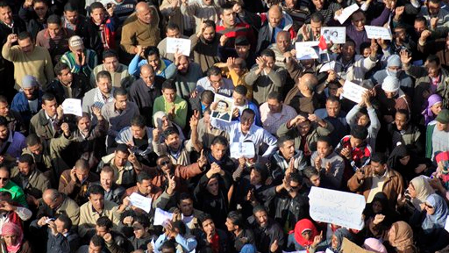 Sunday: Some of the thousands of Egyptian protesters shout anti-Mubarak slogans during a protest in Cairo, Egypt. The army sent hundreds more troops and armored vehicles onto the streets of Cairo and other cities but appeared to be taking little action against mass protests.