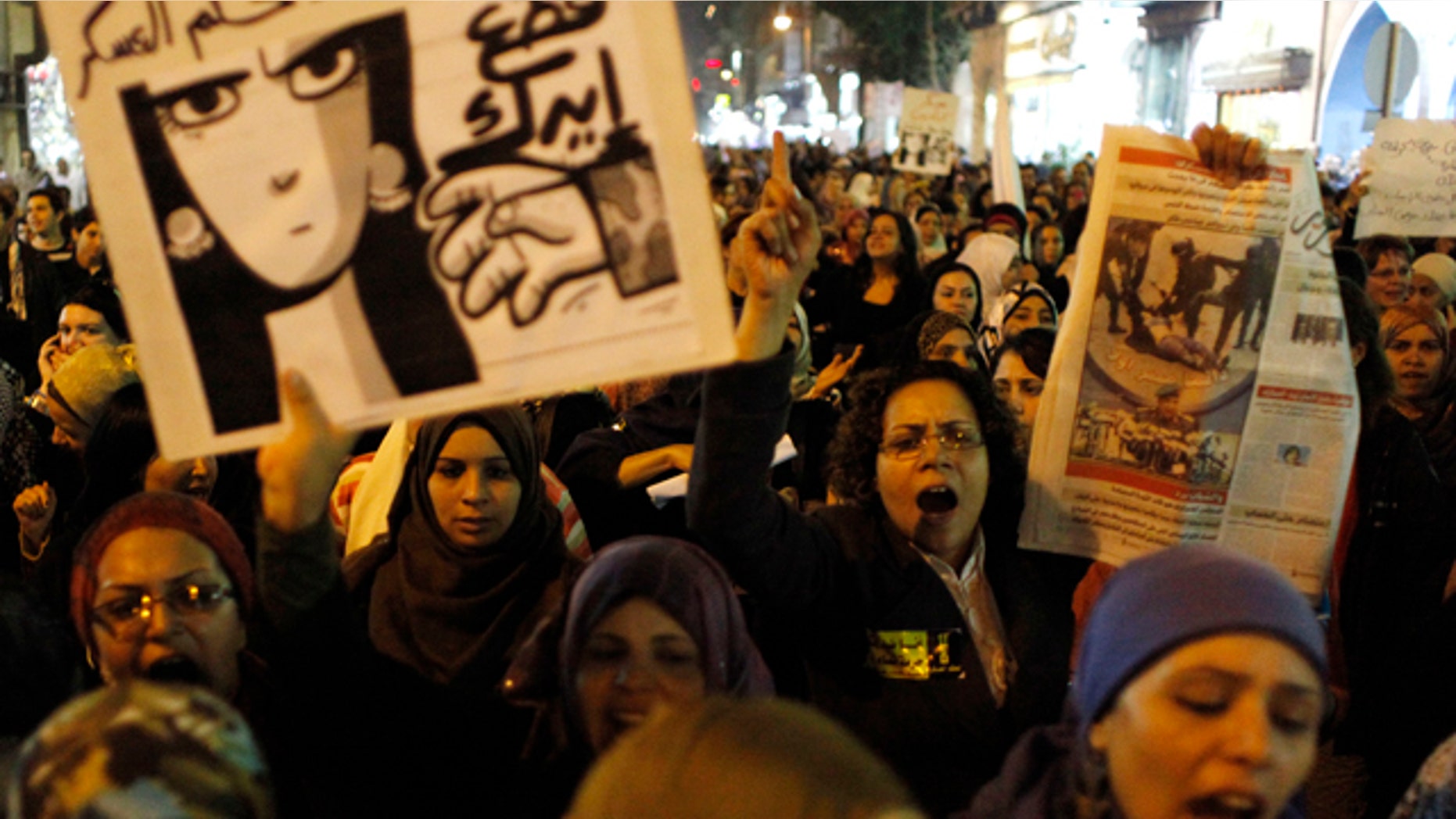 Dec. 20, 2011: Egyptian women angered by the recent violence used against them in clashes between army soldiers and protesters, one carrying a poster that reads in Arabic "Down with military rule, Military are liars and We will cut your hand" chant anti military slogans during rally that ended in Tahrir Square, Cairo, Egypt.