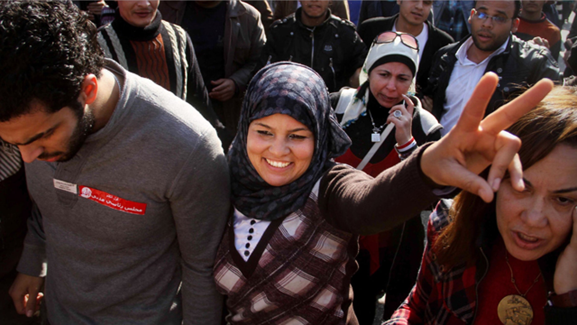 Dec. 27, 2011: Samira Ibrahim, 25, flashes the victory sign during a rally supporting women's rights in Cairo, Egypt. An Egyptian court has ordered the country's military rulers to stop the use of "virginity tests" on female detainees, a practice that has caused an uproar among activists and rights. Ibrahim filed a lawsuit after being subjected to a forced 'test."
