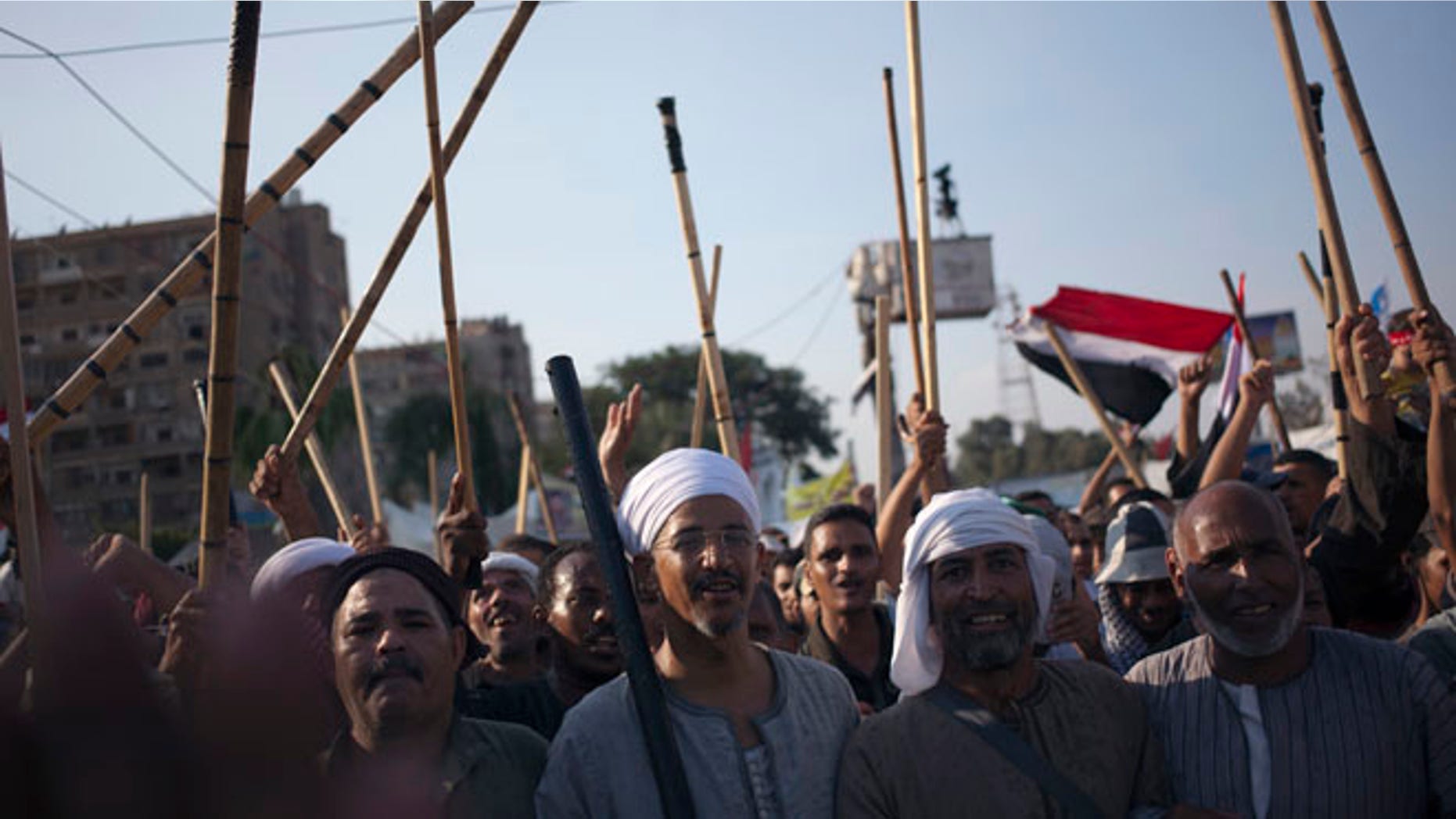 Aug. 10, 2013: Supporters of Egypt's ousted President Mohammed Morsi hold up wooden sticks as they participate in a protest outside Rabaah al-Adawiya mosque, where protesters have installed a camp and held daily rallies at Nasr City, in Cairo, Egypt.