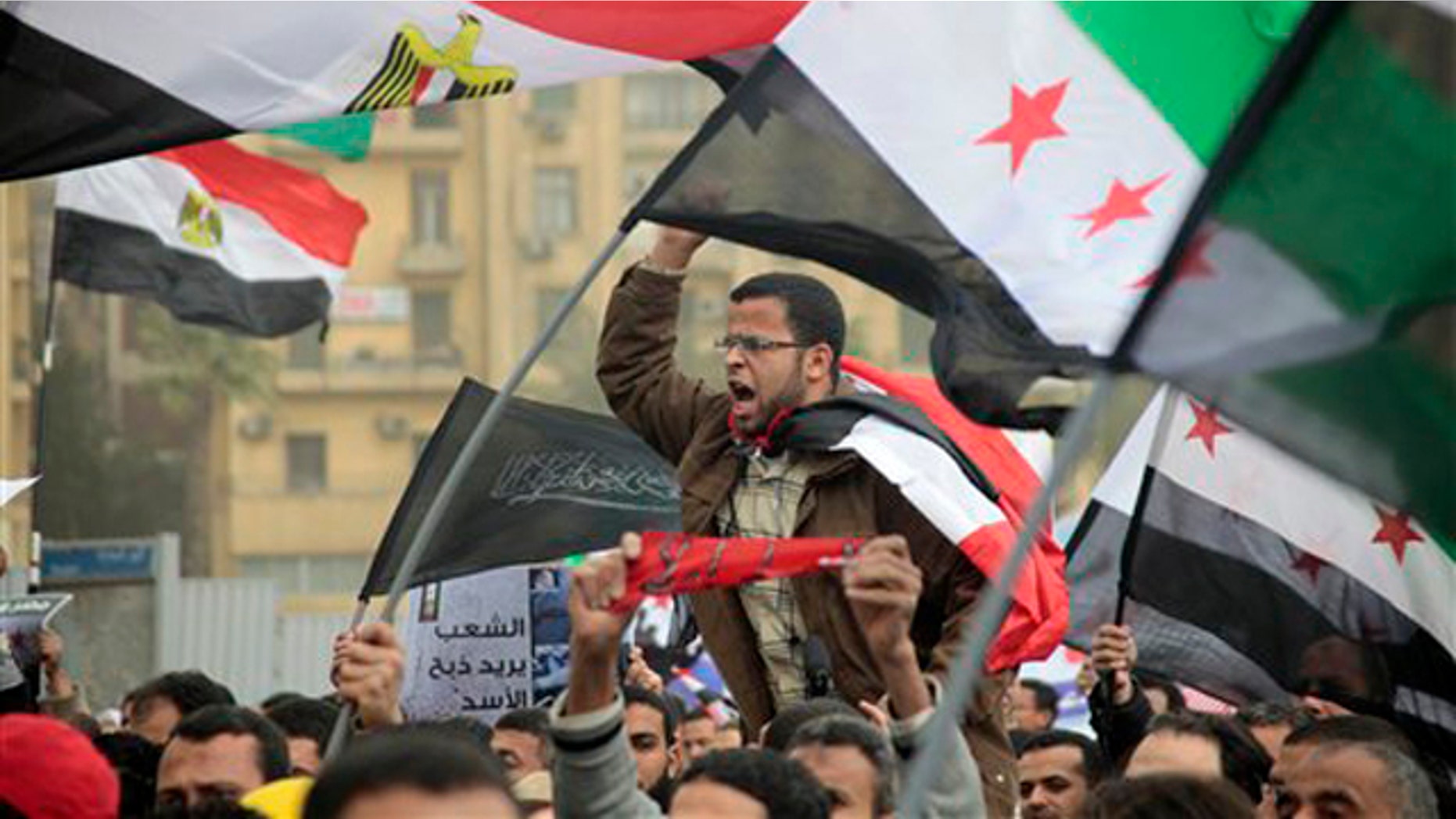 Feb. 17, 2012: Syrian and Egyptian protesters shout slogans during a demonstration against Syrian President Bashar al-Assad in front of the Syrian embassy in Cairo, Egypt.