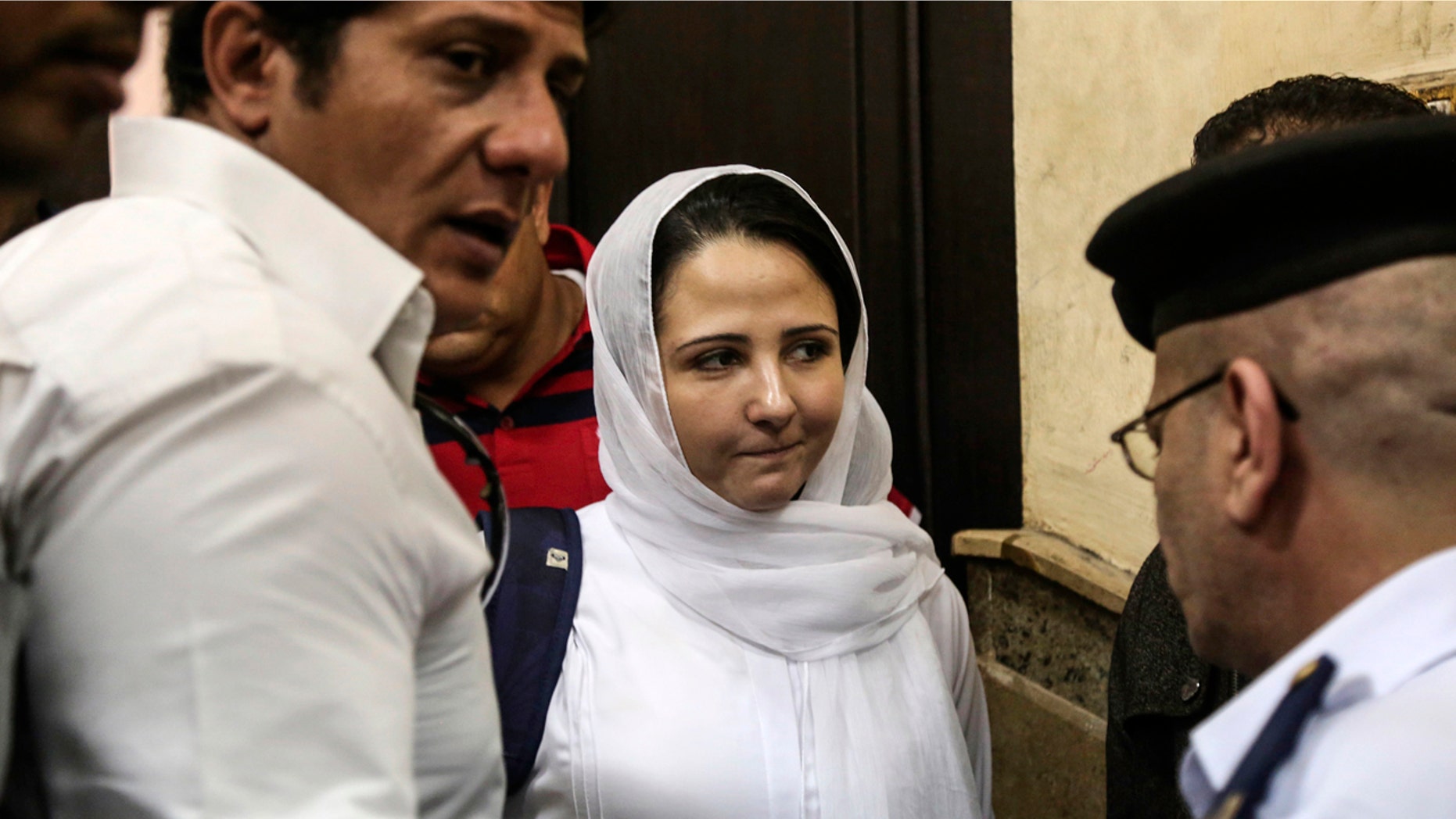 Aya Hijazi, center, a dual U.S.-Egyptian citizen, is acquitted by an Egyptian court after nearly three years of detention over accusations related to running a foundation dedicated to helping street children, Cairo, Sunday, April 16, 2017. Egyptian authorities arrested Hijazi, her husband and six others in May 2014 on charges of abusing children in her care and engaging in human trafficking, kidnapping, sexual exploitation and torture. (AP Photo/Mohamed el Raai)