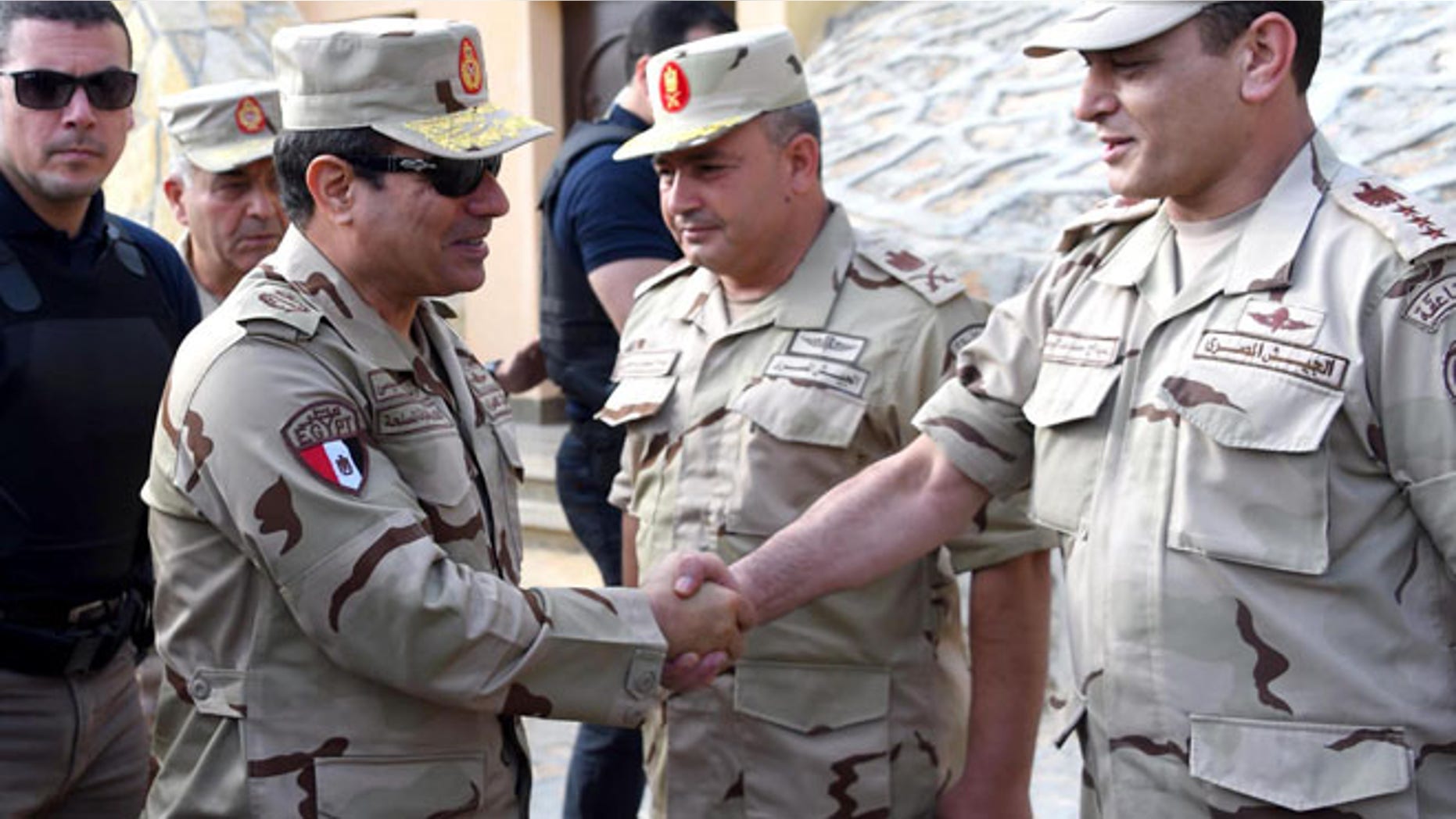 July 4, 2015: In this picture provided by the office of the Egyptian Presidency, Egyptian President Abdel-Fattah el-Sissi, second left, greets members of the Egyptian armed forces in Northern Sinai, Egypt. (AP)