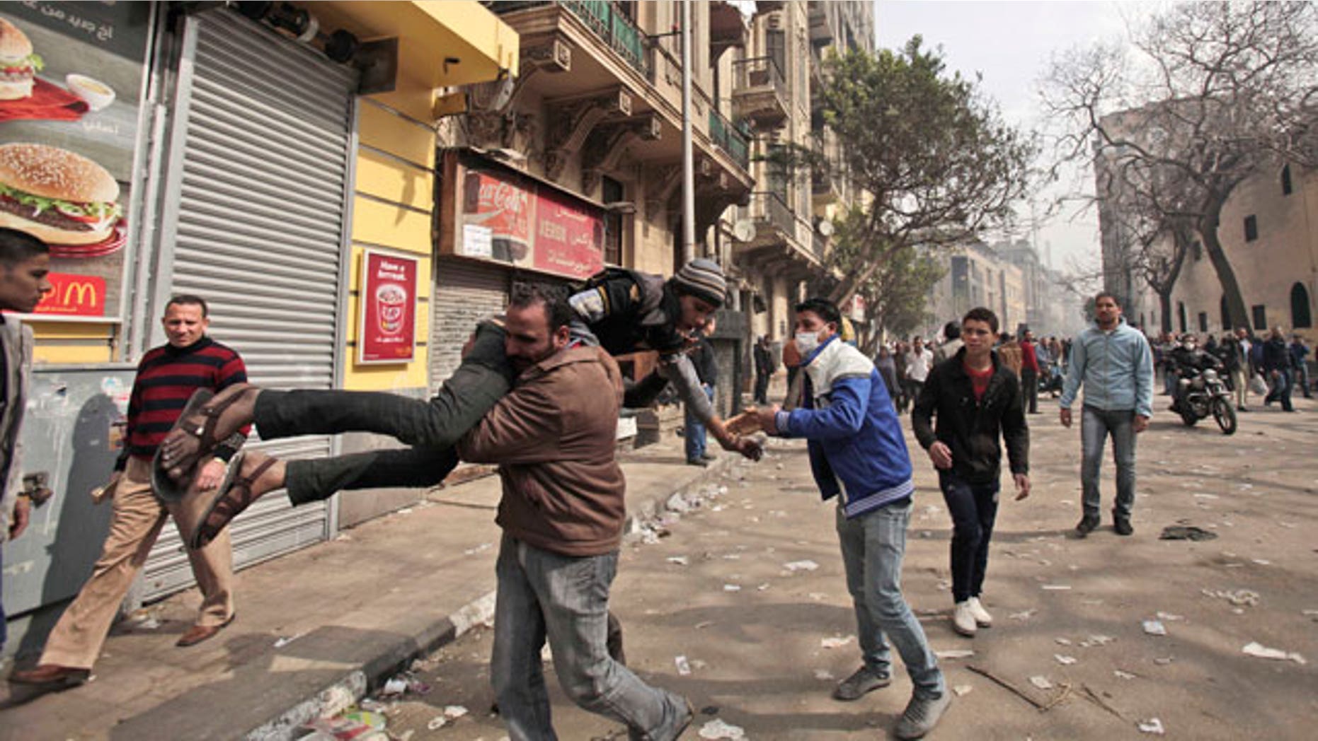 Feb. 6, 2012: An Egyptian protestor injured in clashes with security forces is carried to a field hospital during clashes near the Interior Ministry in Cairo, Egypt.