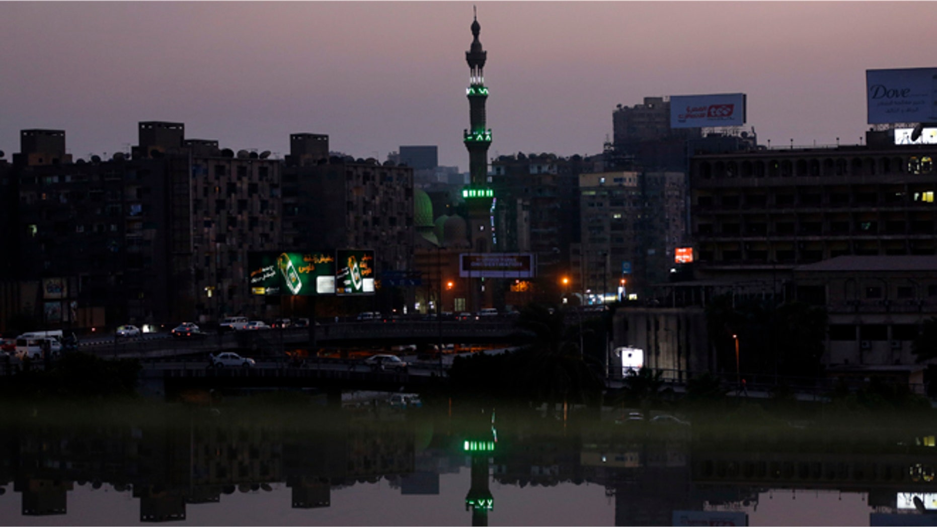 Aug. 25, 2013: A mosque's minaret near the river Nile river is reflected on an open office window in Cairo, Egypt. (AP/Lefteris Pitarakis)