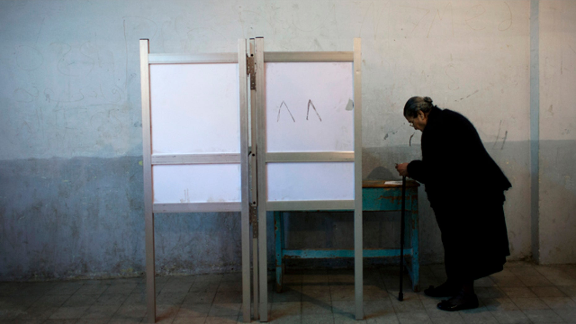 Dec. 15, 2012: An Egyptian woman votes at polling center during a referendum on a disputed constitution drafted by Islamist supporters of President Mohammed Morsi in Cairo.