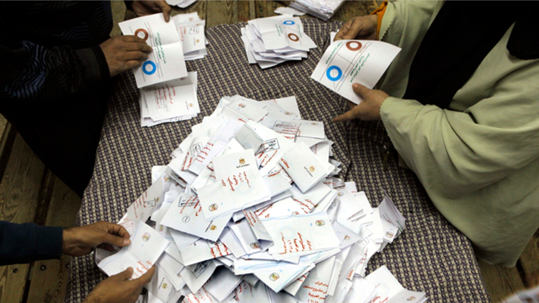 Dec. 15, 2012: Egyptian referendum officials count votes at a polling station in Cairo, Egypt.