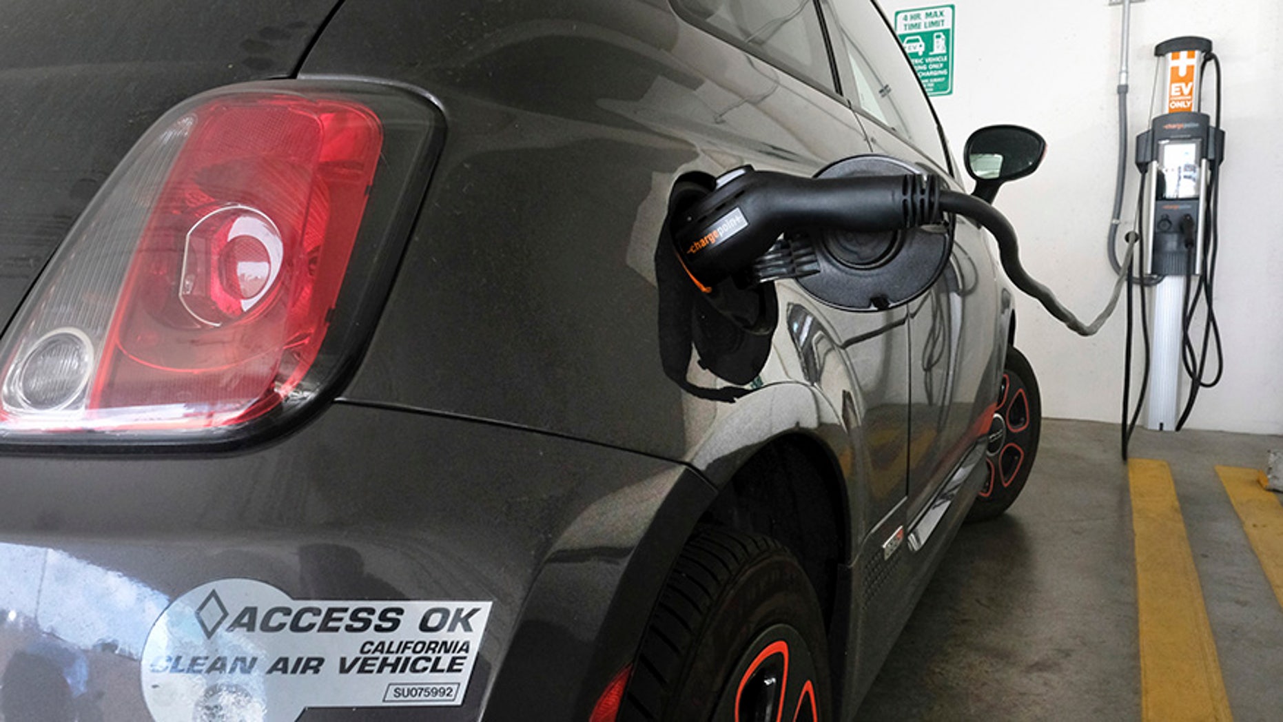 This April 25, 2016, photo shows an electric Fiat plugged into a charging station in a parking lot in Los Angeles. California could spend up to $3 billion under a bill that would widely expand its consumer rebate program for zero-emission vehicles. The Legislature is pushing forward a bill that could lift rebates from $2,500 to $10,000 or more for a compact electric car. Current rebates have done little to boost sales. (AP Photo/Richard Vogel)