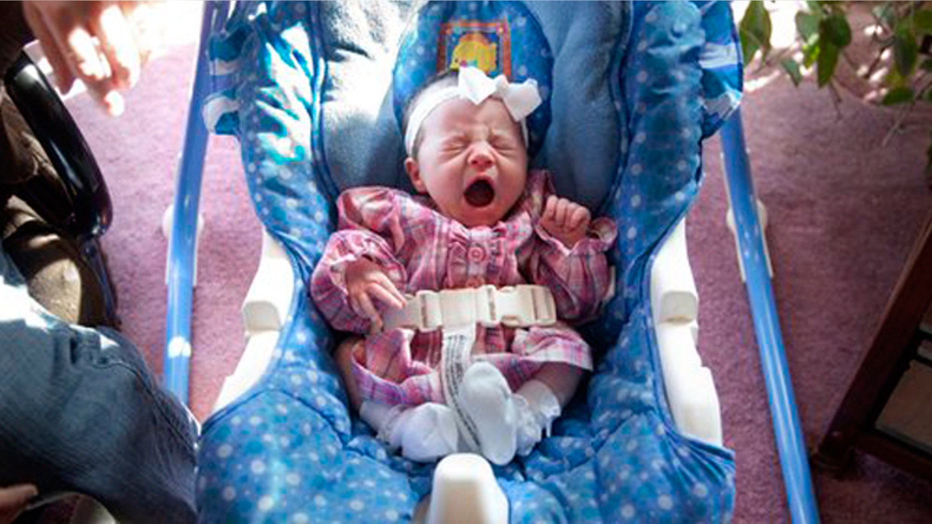 Alyssa Lynn Leming gives a big yawn in her rocker on Monday, Feb. 21, 2011 in her Lecompton, Kan. home. Alyssa was born in a hospital elevator.