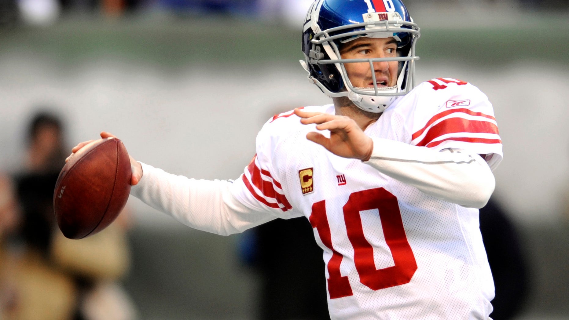 In this Dec. 24, 2011, file photo, New York Giants quarterback Eli Manning looks to pass during the second quarter of an NFL football game against the New York Jets, in East Rutherford, N.J.