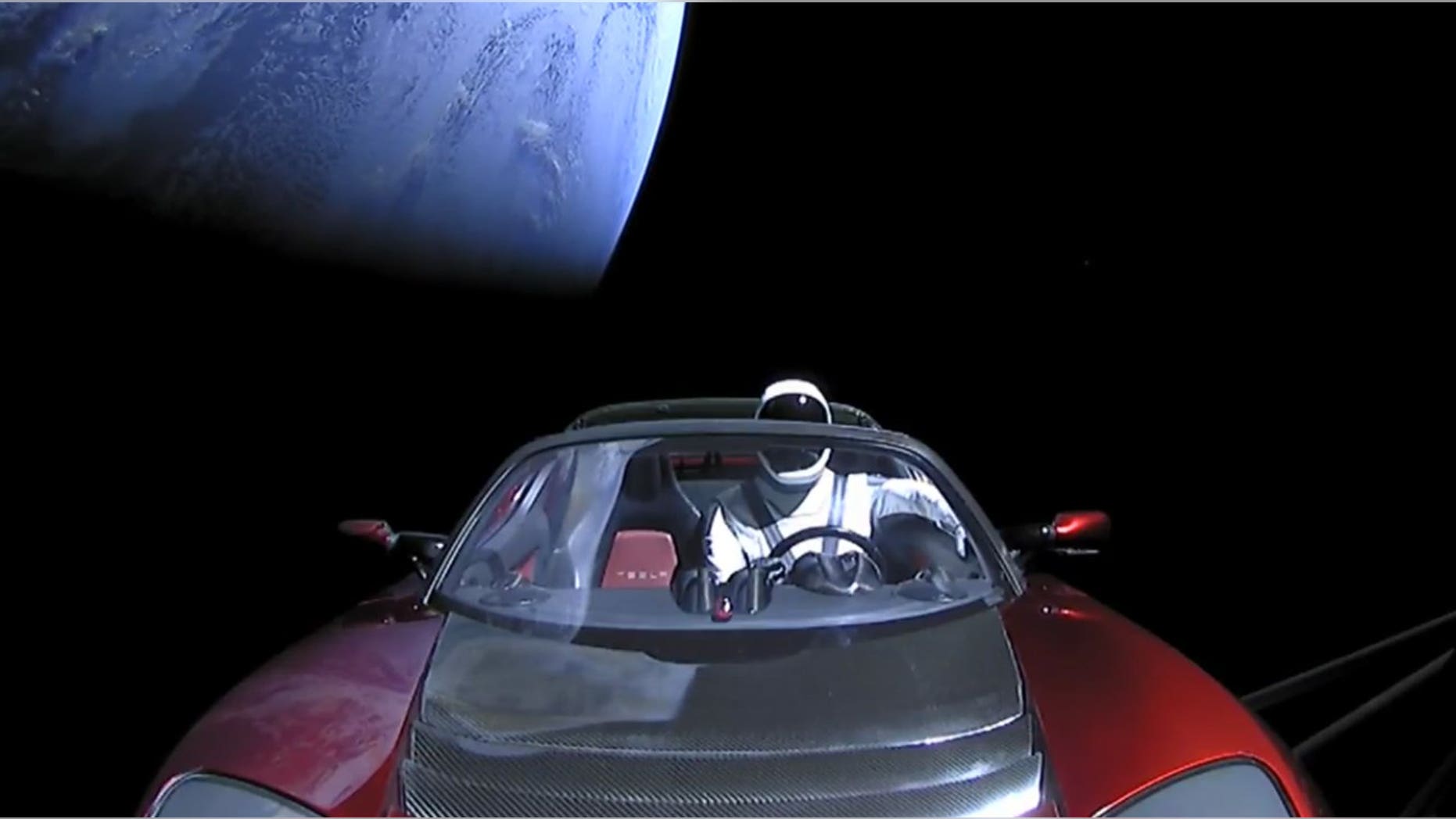 Starman and his Tesla leave Earth behind shortly after launching atop SpaceX's Falcon Heavy rocket on Feb. 6, 2018.