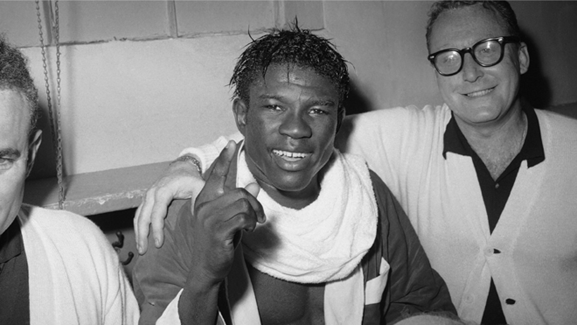 In this June 8, 1963 file photo, Emile Griffith smiles in the dressing room after regaining his welterweight world championship title by defeating Luis Rodriguez, at New York’s Madison Square Garden.
