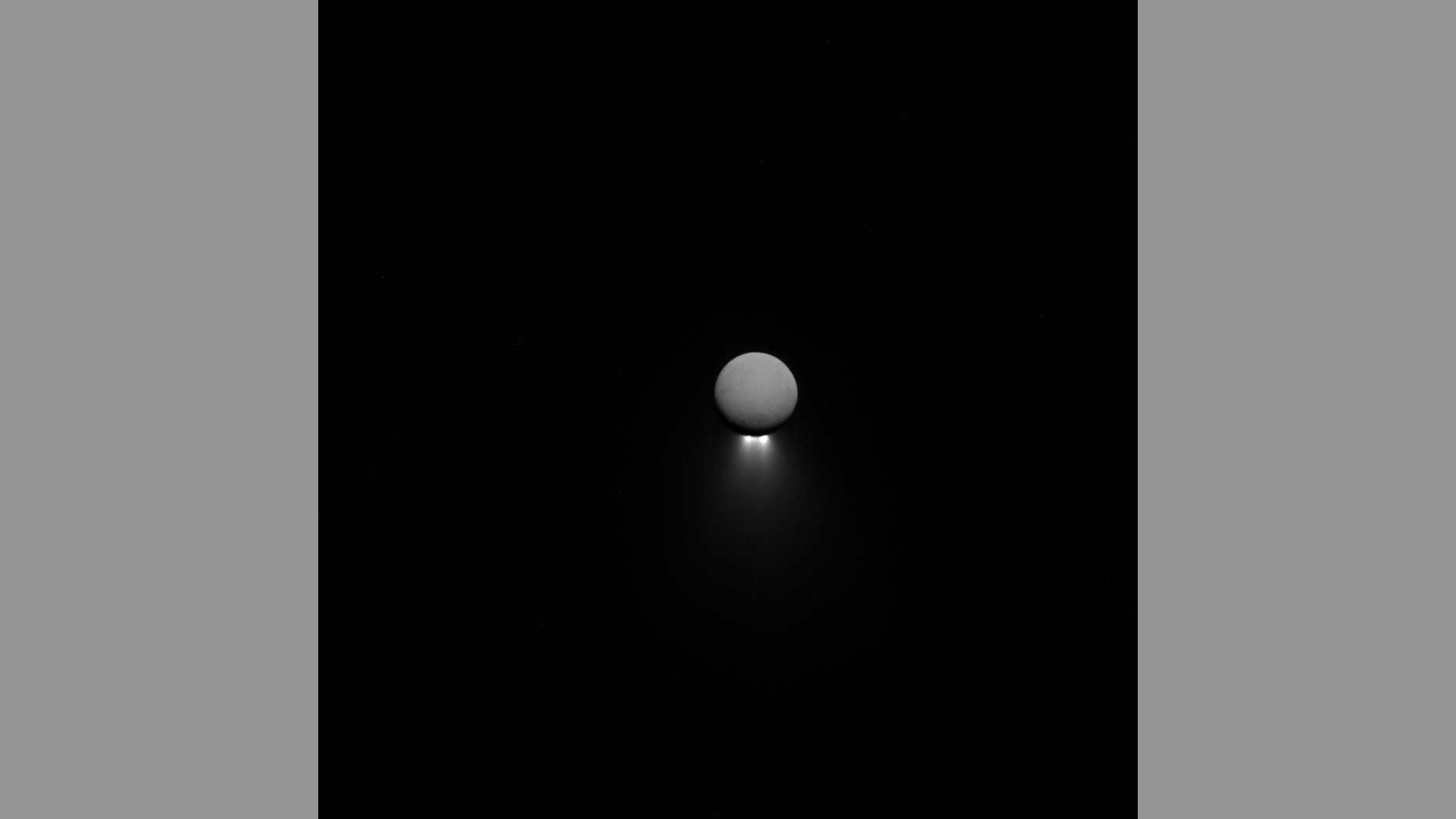 Saturn's moon Enceladus releases jets of water ice as imaged by the Cassini spacecraft in April. The moon shines in reflected Saturn light, while the jets are backlit by the sun.
