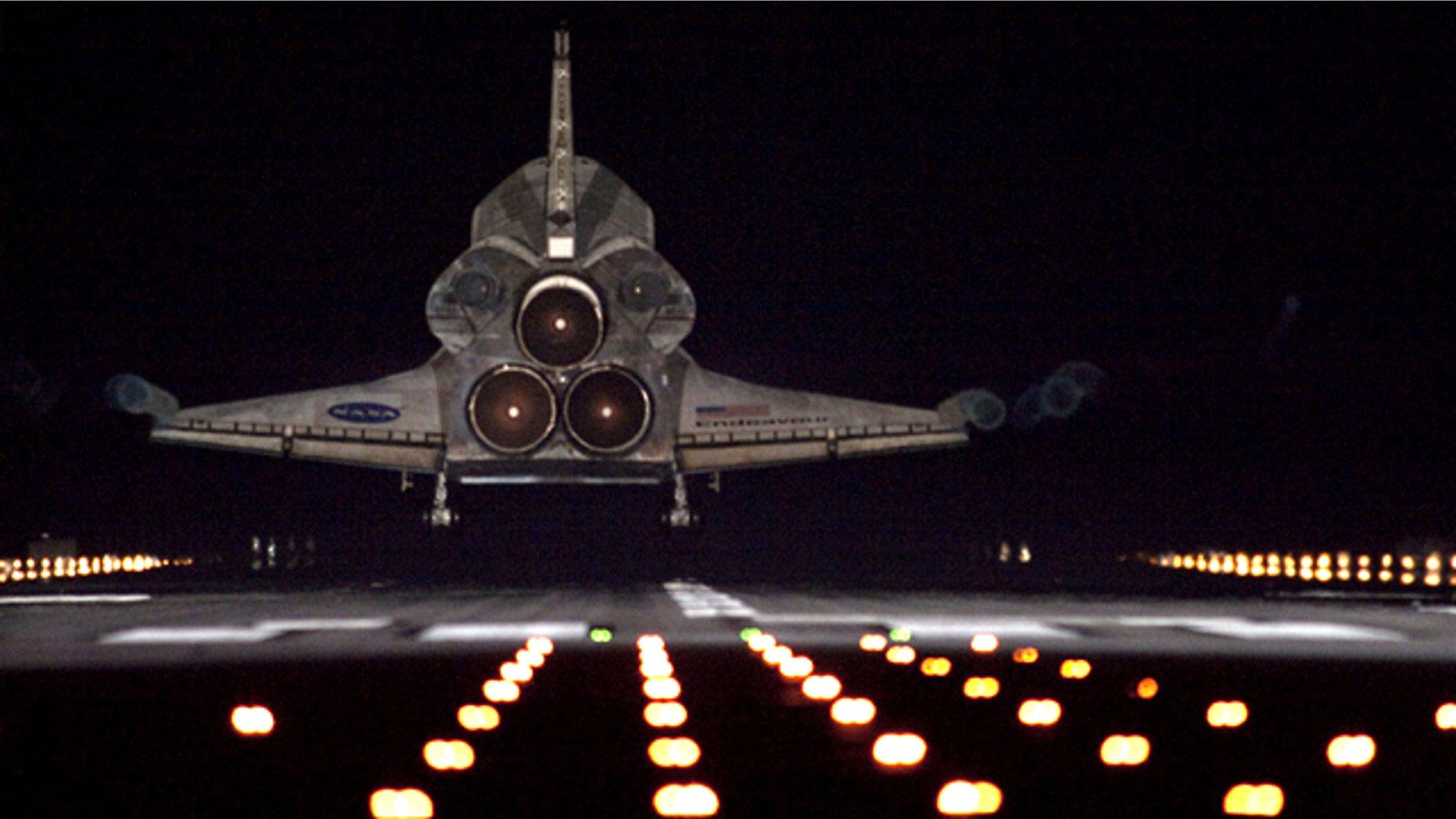 Runway lights help lead space shuttle Endeavour, seen here from behind, home to NASA's Kennedy Space Center in Florida. Endeavour landed for the final time on the Shuttle Landing Facility's Runway 15, on June 1, 2011, marking the 24th night landing of NASA's Space Shuttle Program.