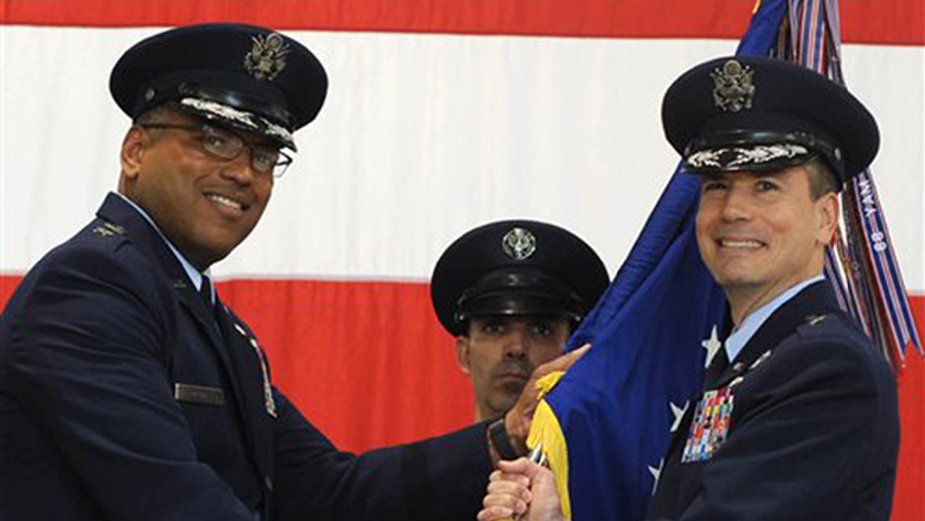 In this photo provided by the U.S. Air Force, Brig. Gen. Paul W. Tibbets IV, right, receives the the 509th Bomb Wing guidon from Air Force Maj. Gen. Richard Clark, left, to take over leadership of the United States' aging fleet of nuclear-capable B-2 stealth bombers at Whiteman Air Force Base, Mo.