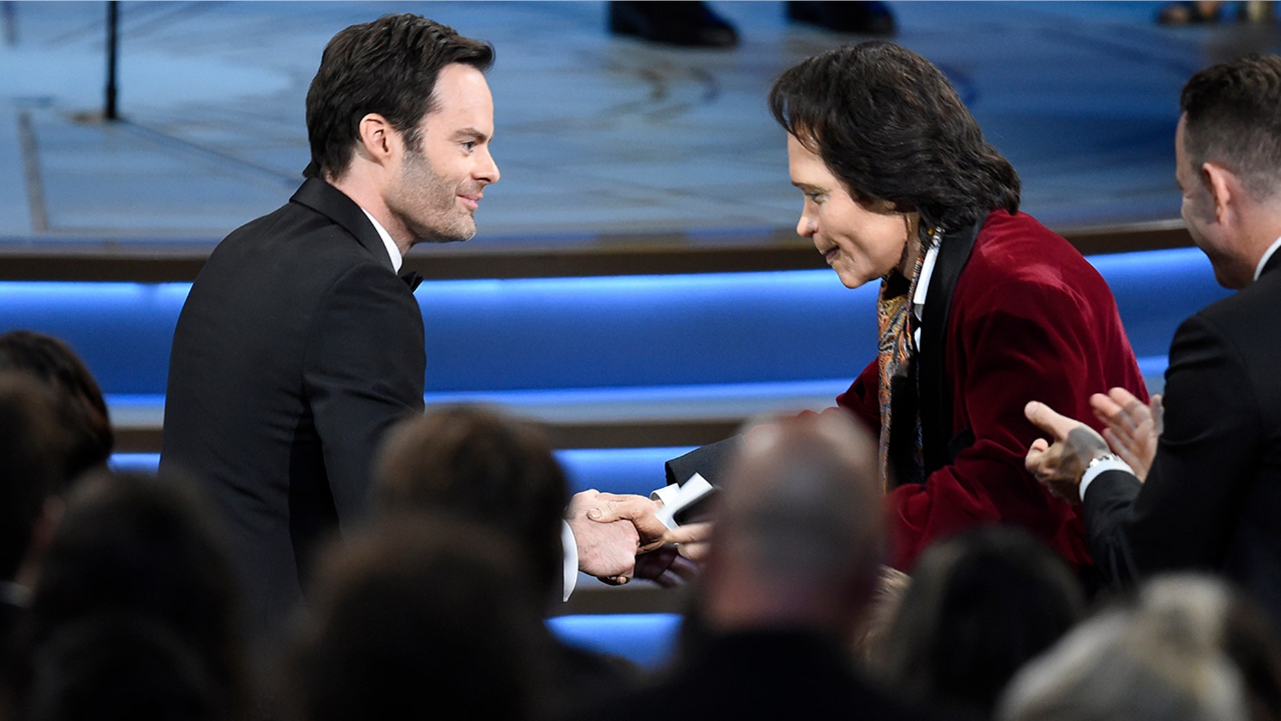 Teddy Perkins, right, congratulates Bill Hader as he gets ready to walk on stage to accept the award for outstanding lead actor in a comedy series for "Barry" at the 70th Primetime Emmy Awards.