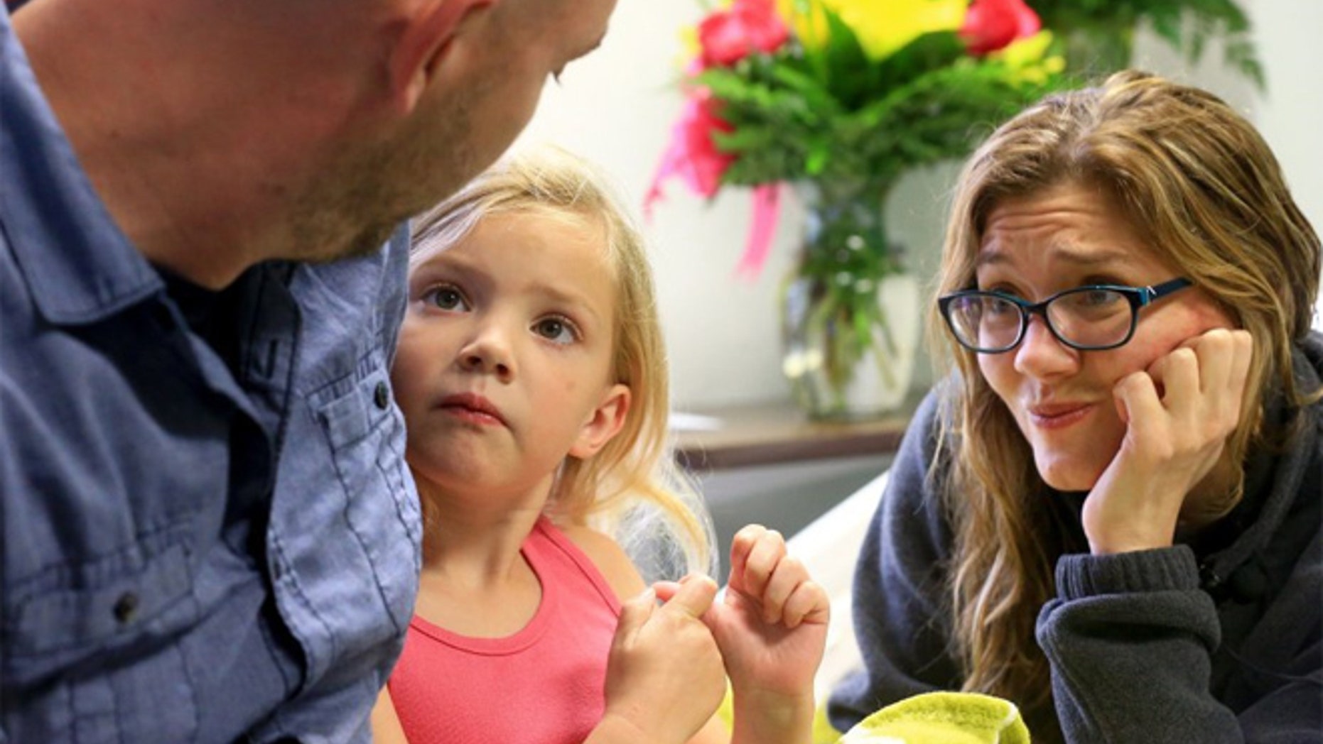 Ryan Anderwald hugs his daughter Allison, 5, as they sit with her mother at Christus Spohn Hospital Memorial in Corpus Christi.