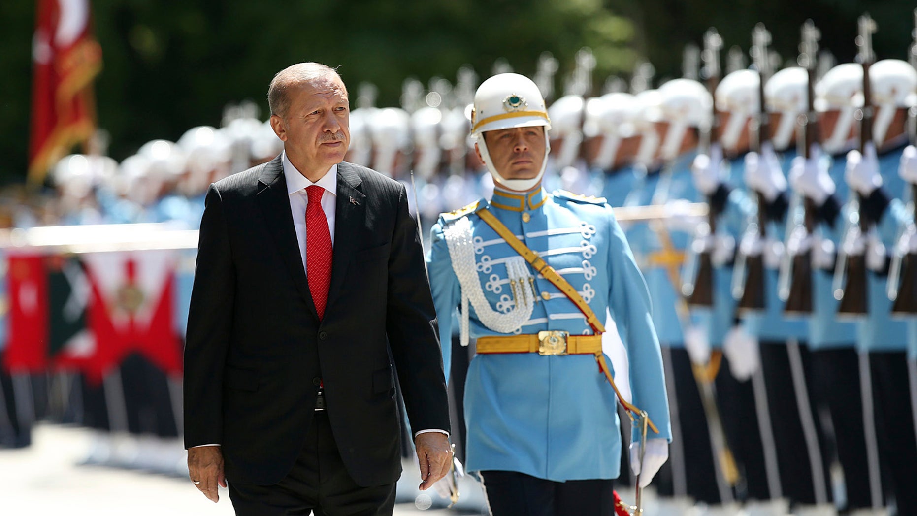 Turkey's President Recep Tayyip Erdogan inspects an honour guard as he arrives at the parliament in Ankara, Turkey to attend opening session of the new parliament in Ankara, Turkey, Saturday, July 7, 2018.