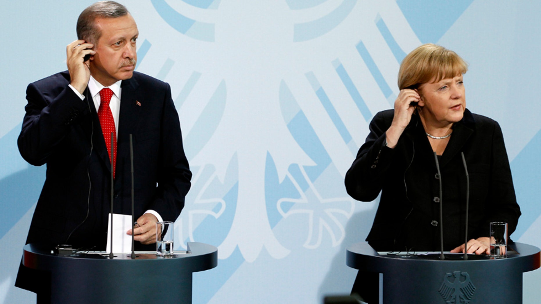 Oct. 31, 2012: German Chancellor Angela Merkel, right, and Turkey's President Recep Tayyip Erdogan, left, address the media during a joint press conference after a meeting at the chancellery in Berlin, Germany.