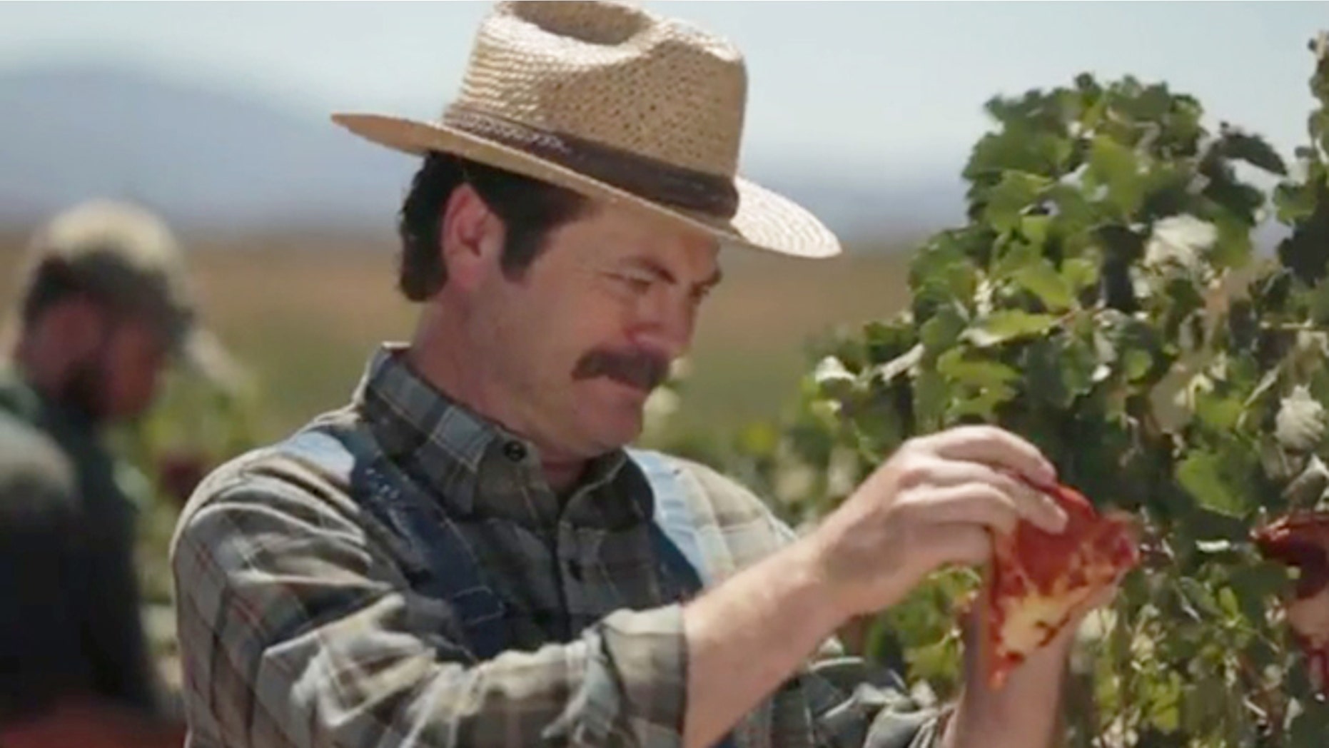 Nick Offerman tends to his juicy, vine-ripened pizza.